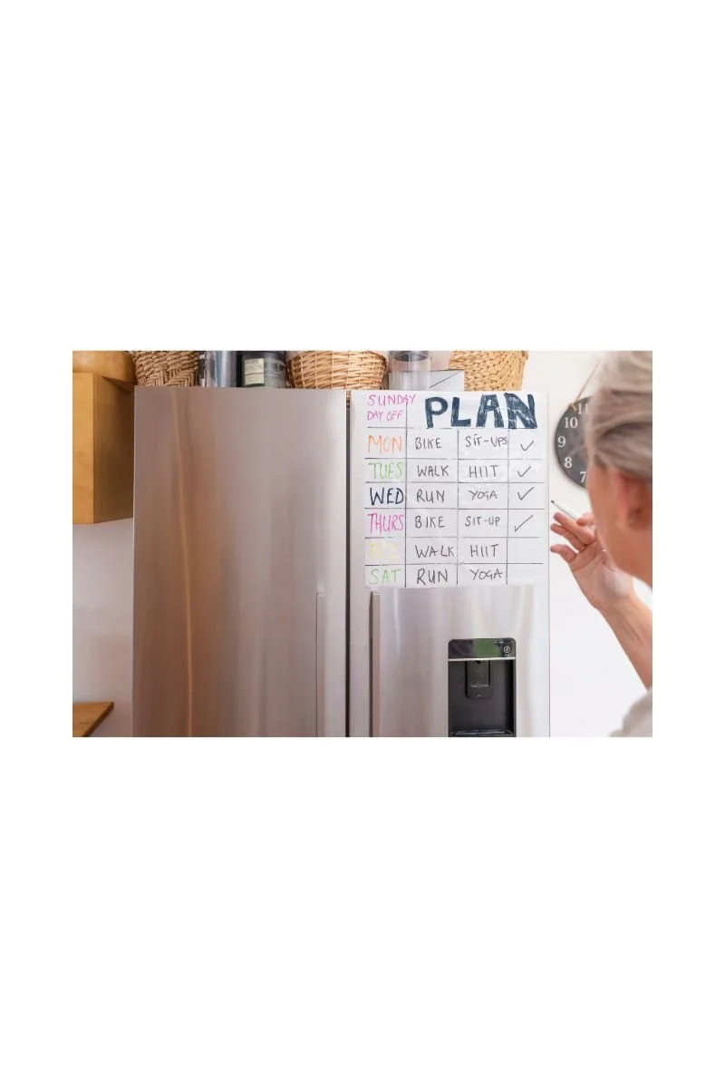 A weekly wellness planner on a refrigerator door, showing intentional time management .