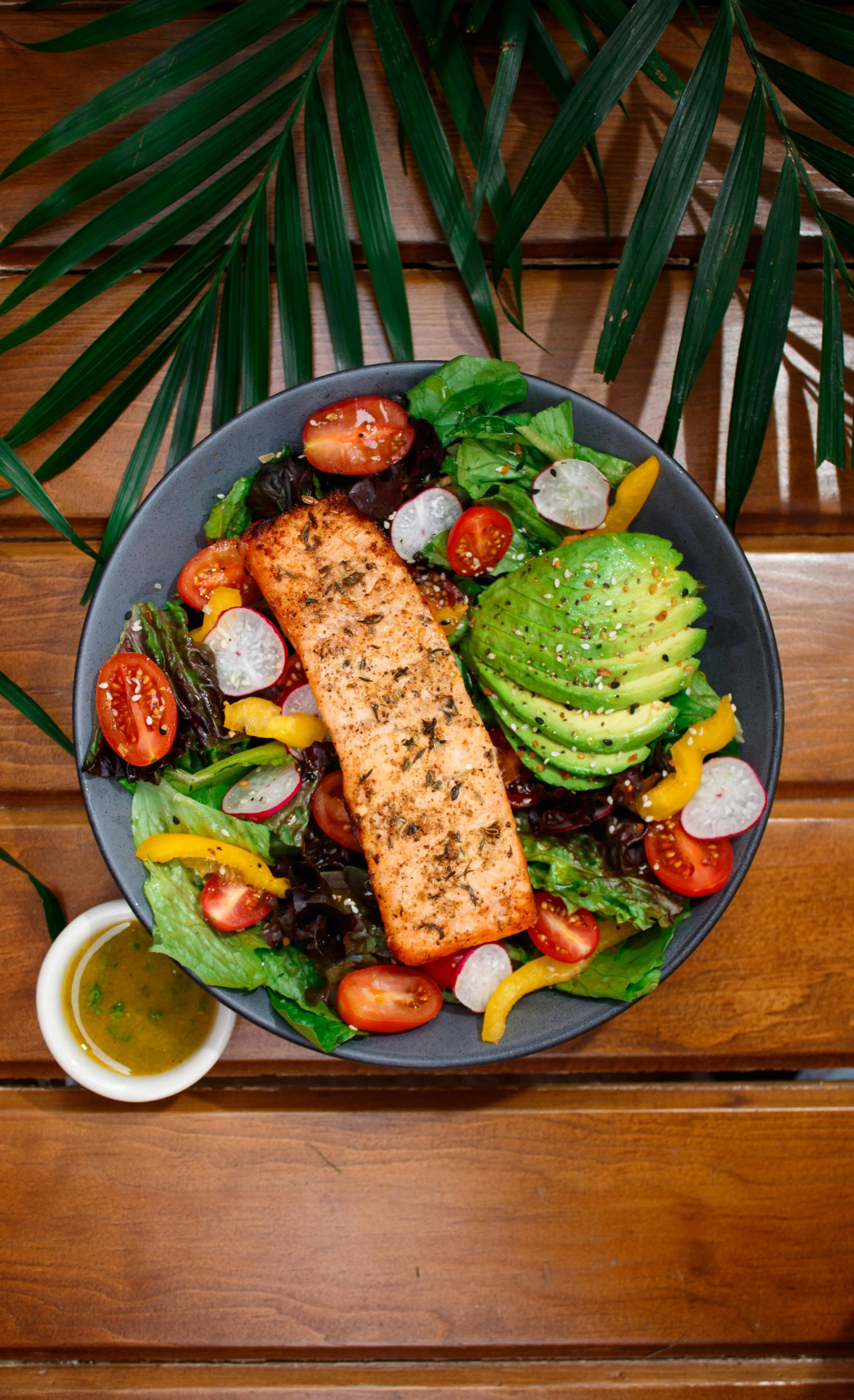 A colorful, mineral-rich meal featuring salmon, avocado, and leafy greens, perfect for fueling mitochondrial function.