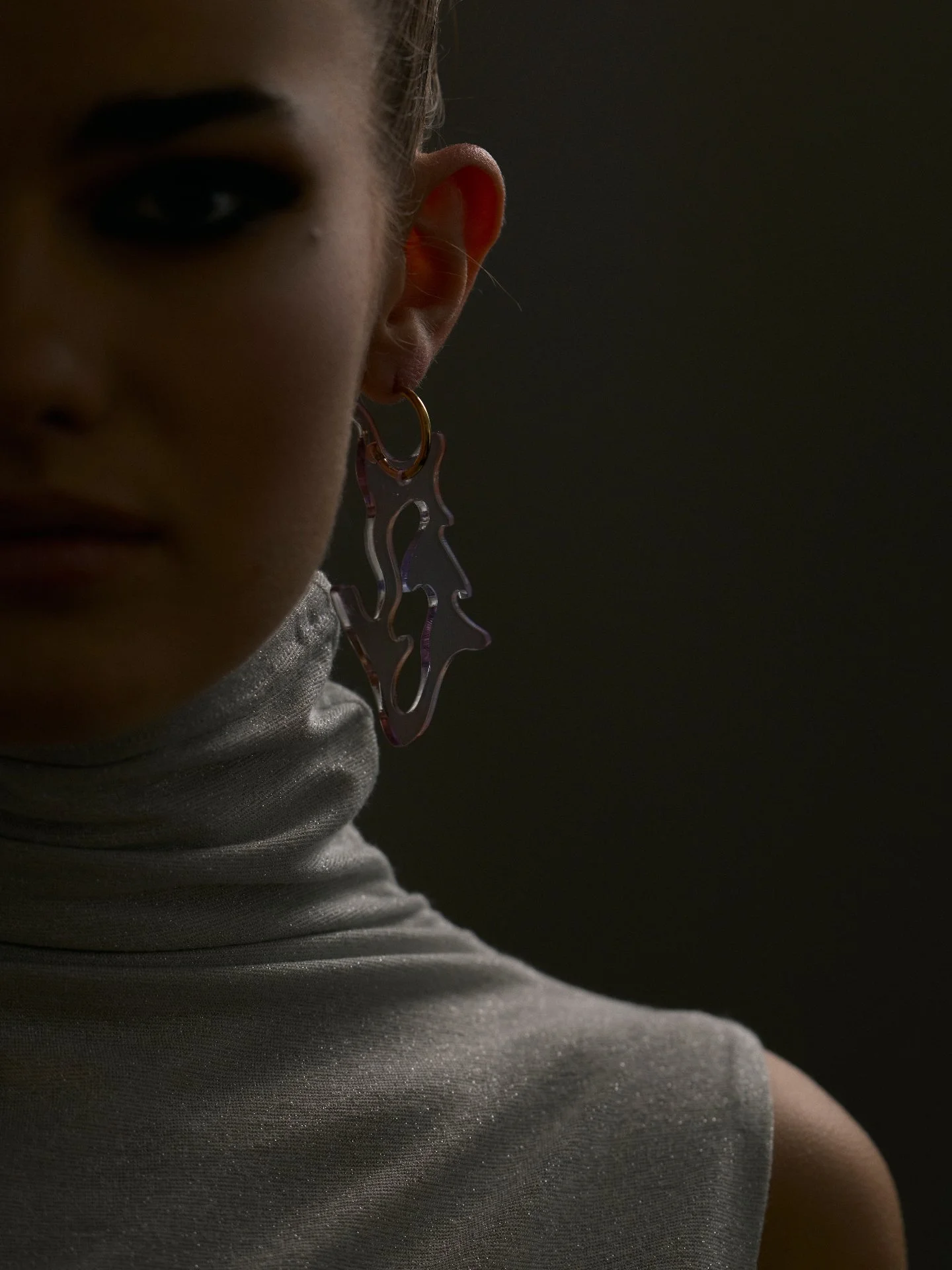 Dramatic light meets sculptural form &mdash; where jewelry becomes visual language.

This image explores the tension between shadow and shape &mdash; a precise play of light that gives form its voice.
At Couture Consultancy, we translate creative vis