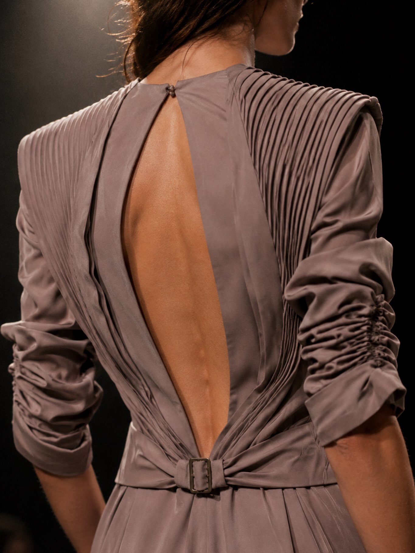 Testing styling ideas for AI-generated shoots.

This one started as an experiment in silhouette, texture and light: structured shoulders, pleated volume, an open back and a soft mauve-grey fabric that feels somewhere between couture detail and modern