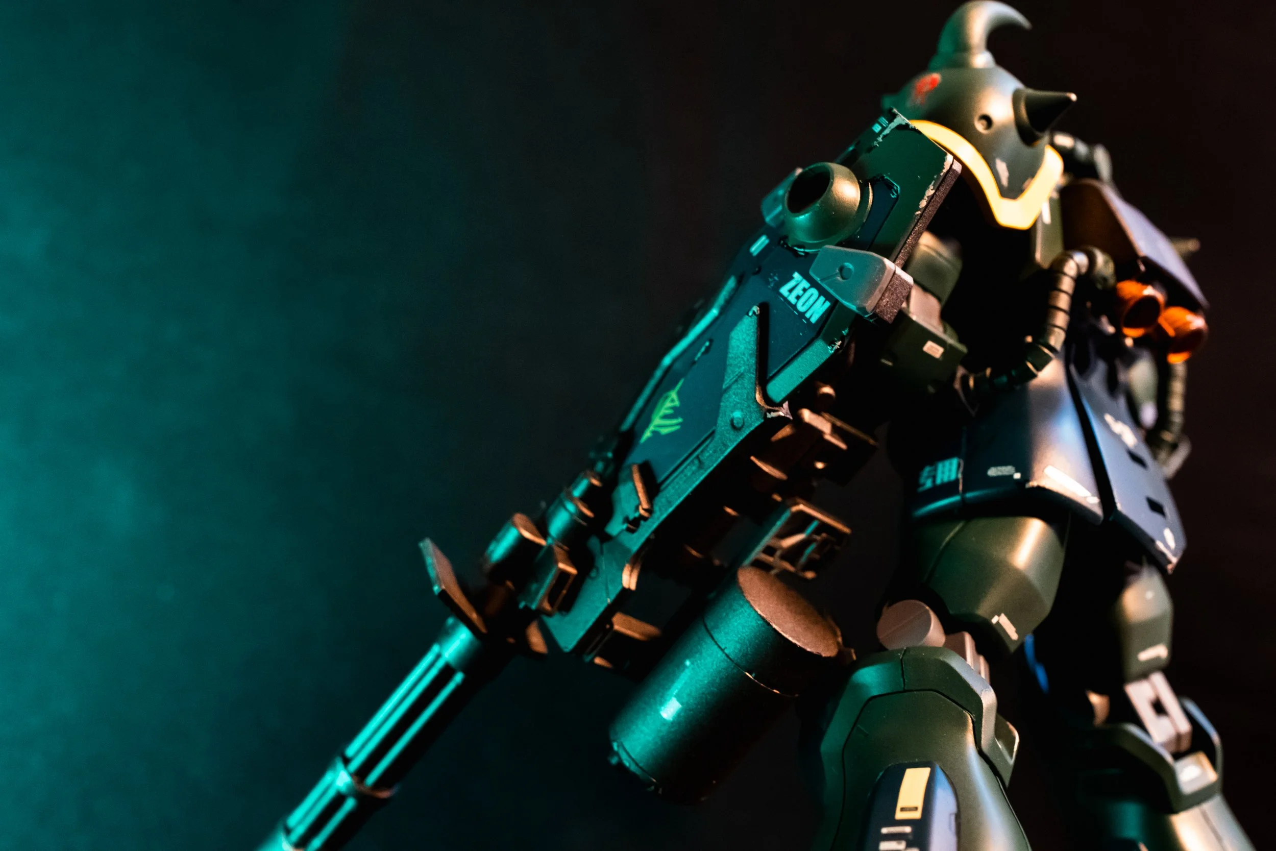 A detailed model of a futuristic robot or mecha with various mechanical parts and accessories, set against a dark background with blue and orange lighting.