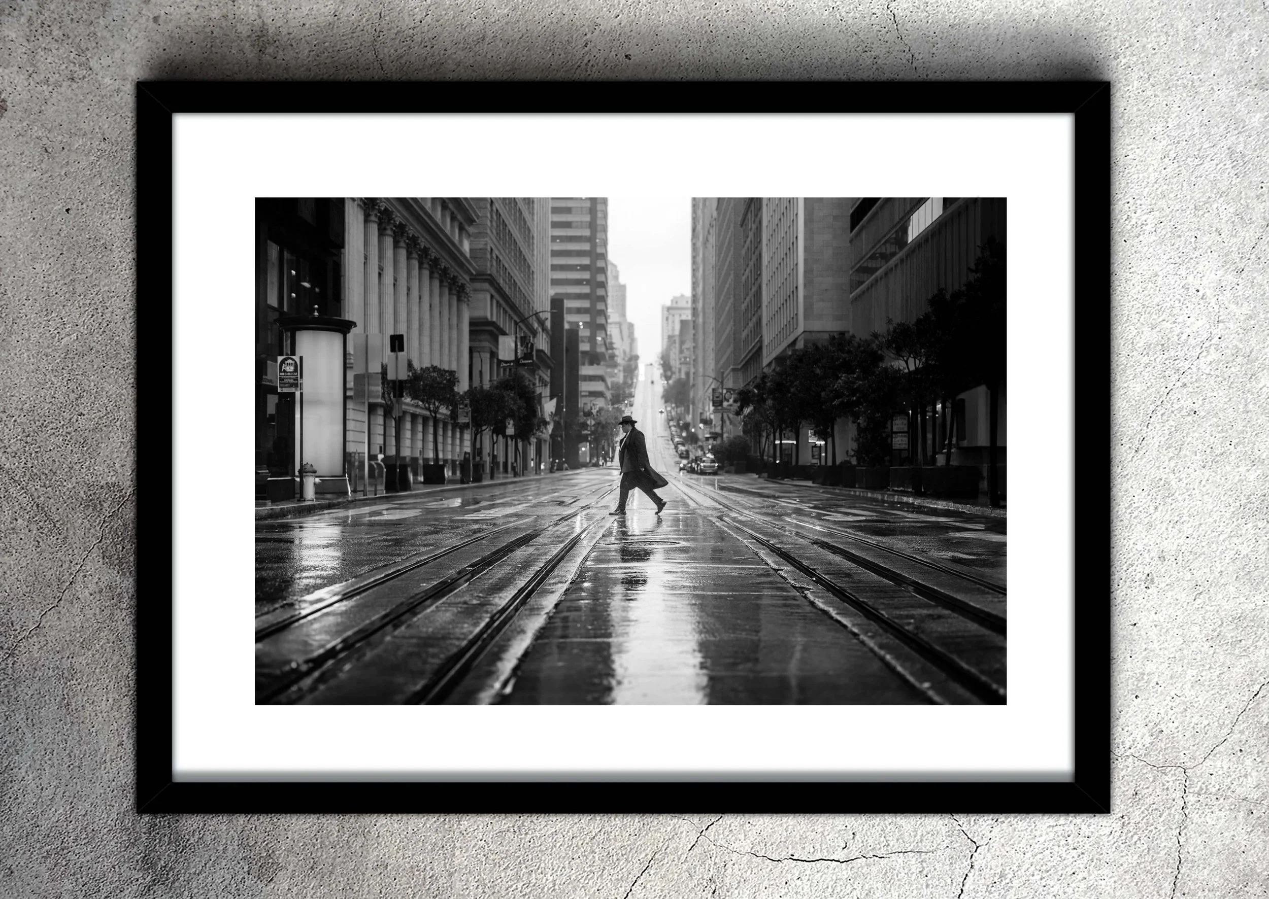 framed black and white image of mysterious man in top hat and long coat striding across rain slicked streets in a cinematic noir style