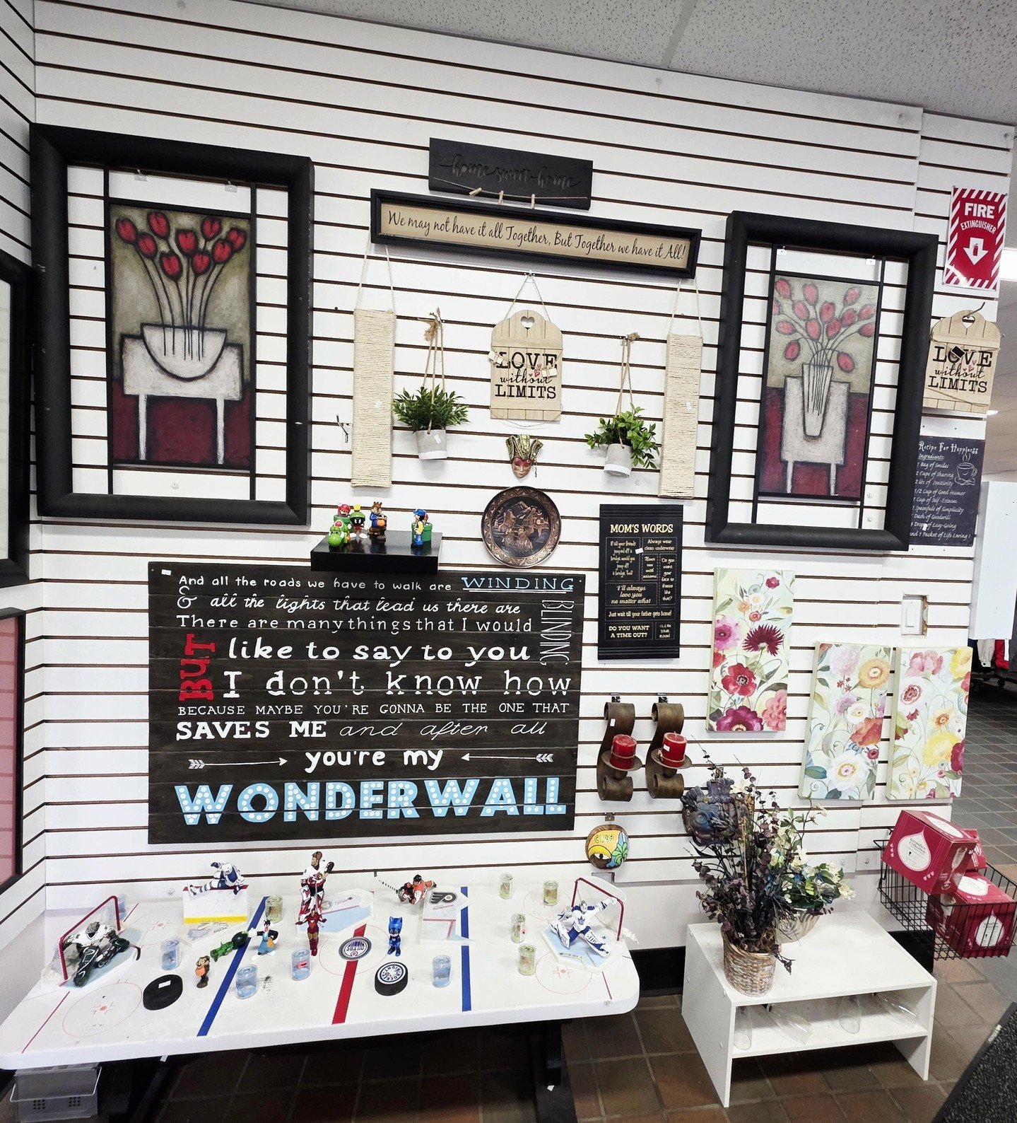 If you&rsquo;ve been waiting for a sign to visit our thrift shop, this is it!

Our team puts a lot of heart into curating the gallery wall at the front of the store, and this time it's bursting with fun signs, unique art, and even some playful cartoo