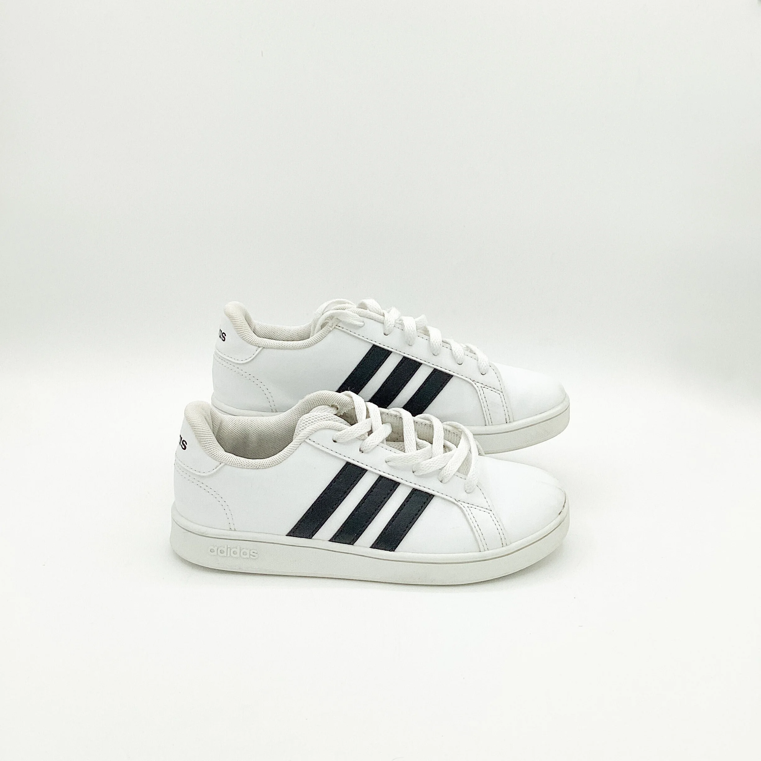 white trainers with black stripe