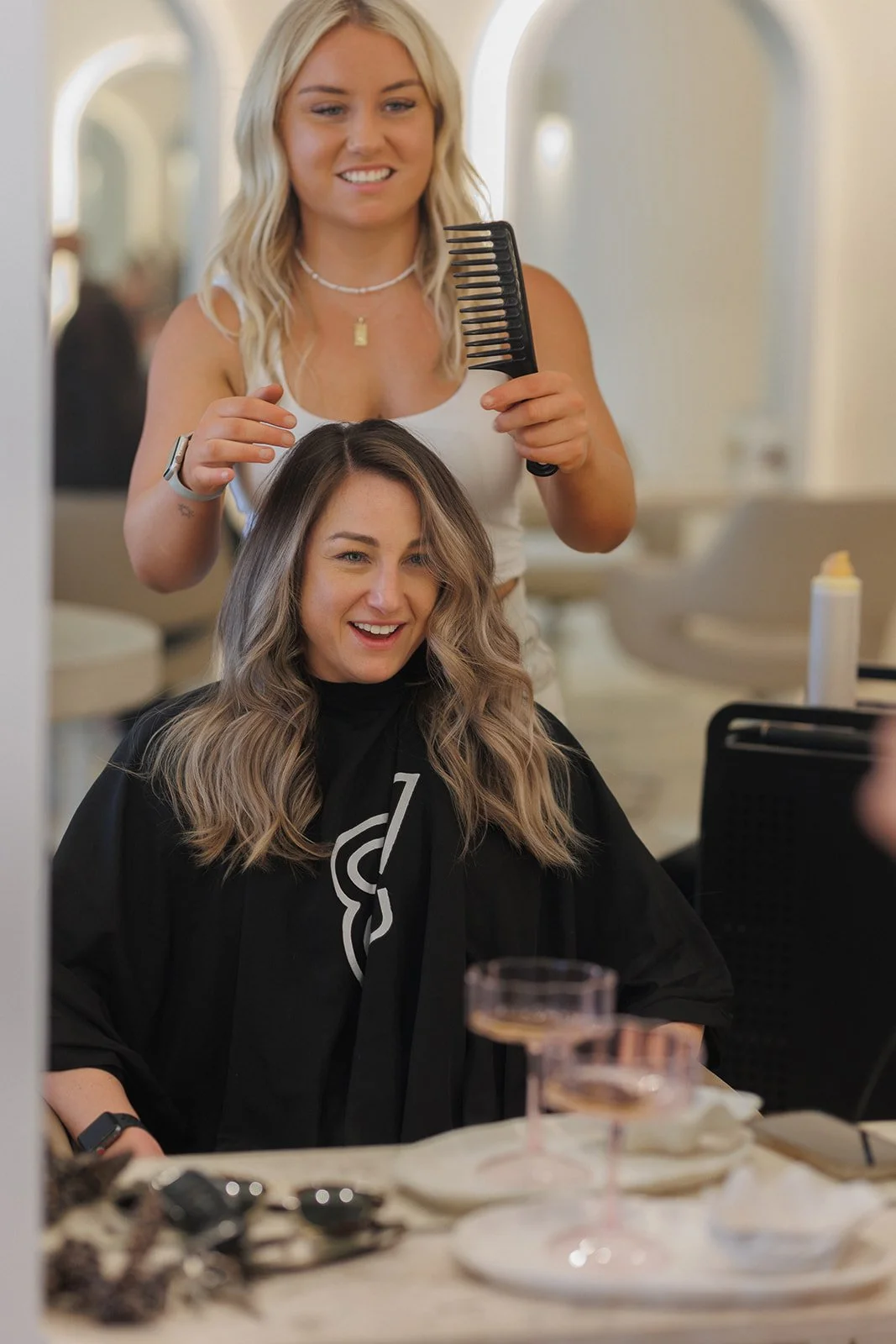 A hairstylist finishing off a luxury cut and hair style
