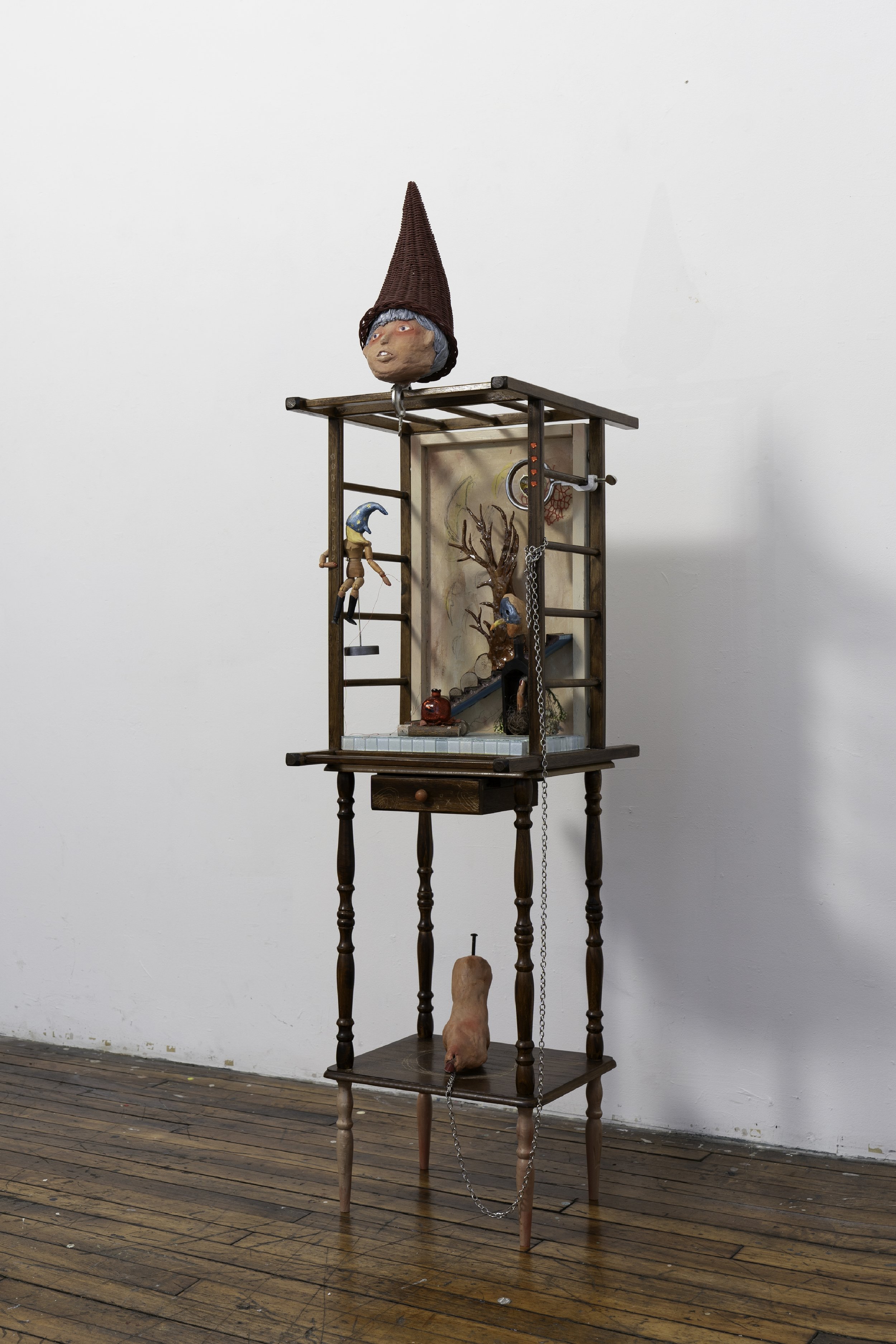   Lured by Red   2025, stone clay, crib, bedside table, canvas, gemstone, wooden finger, wooden figure, magnifying glass, glass pomegranate, wood log, dried flower, fur fabric, acrylic, 20×15×60 inches 