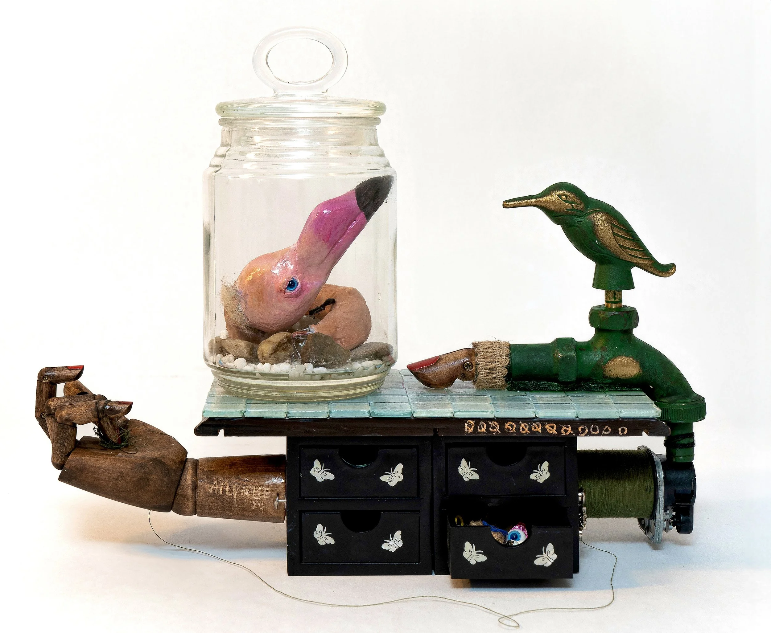    Neither of Us Is Real  , 2024 Stone clay, jewelry box, jar, faucet, glass tile, acrylic, mannequin hand, thread, and epoxy resin 10 × 5 × 8 inches 