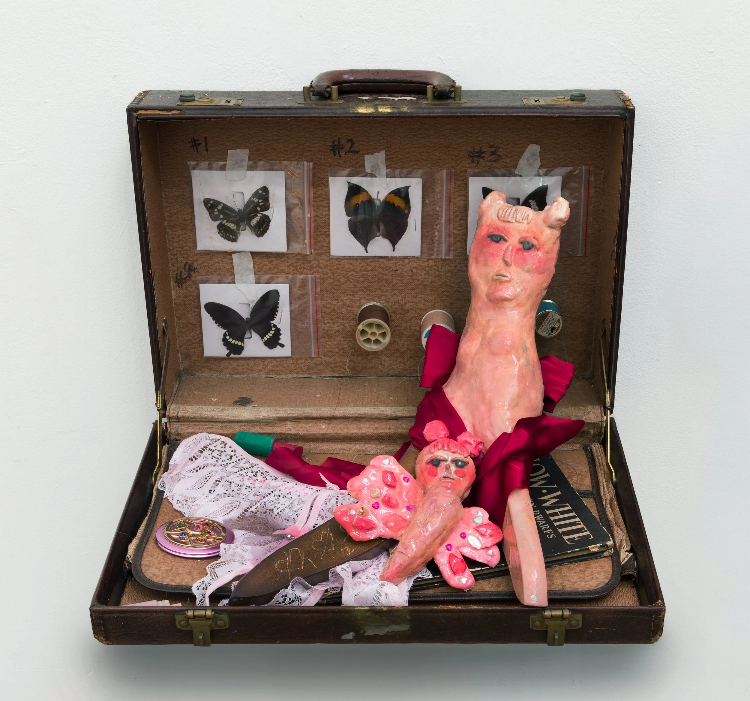   Travel Kit  2025 Suitcase, mirror, butterfly specimen, furniture leg, panties, wooden toy,  Snow White  (1947), stone clay, epoxy, flight ticket, ribbon, sticker, and thread Approx. 13 × 13 × 13 inches 