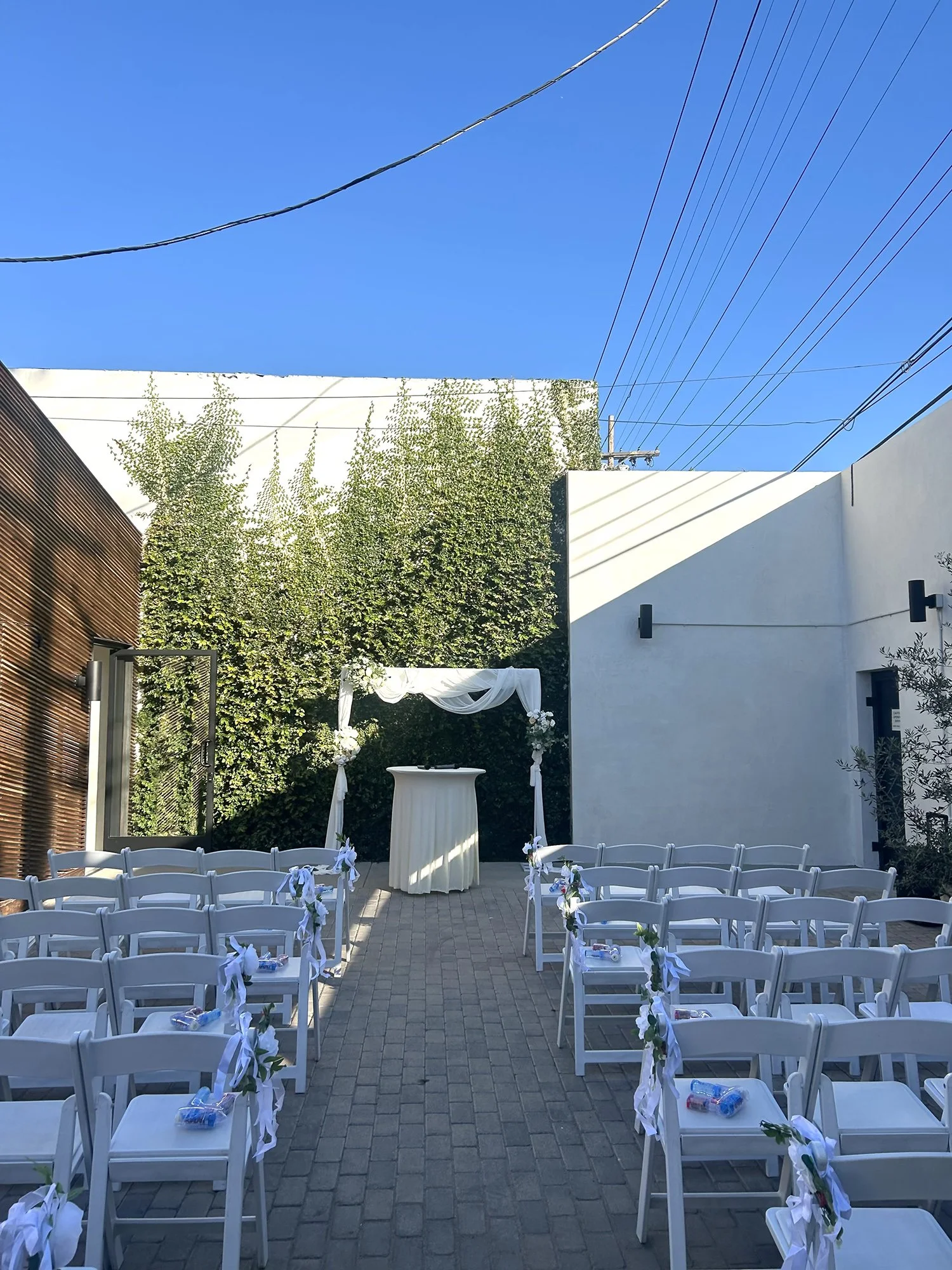 Lacuna wedding ceremony green wall aisle Los Angeles