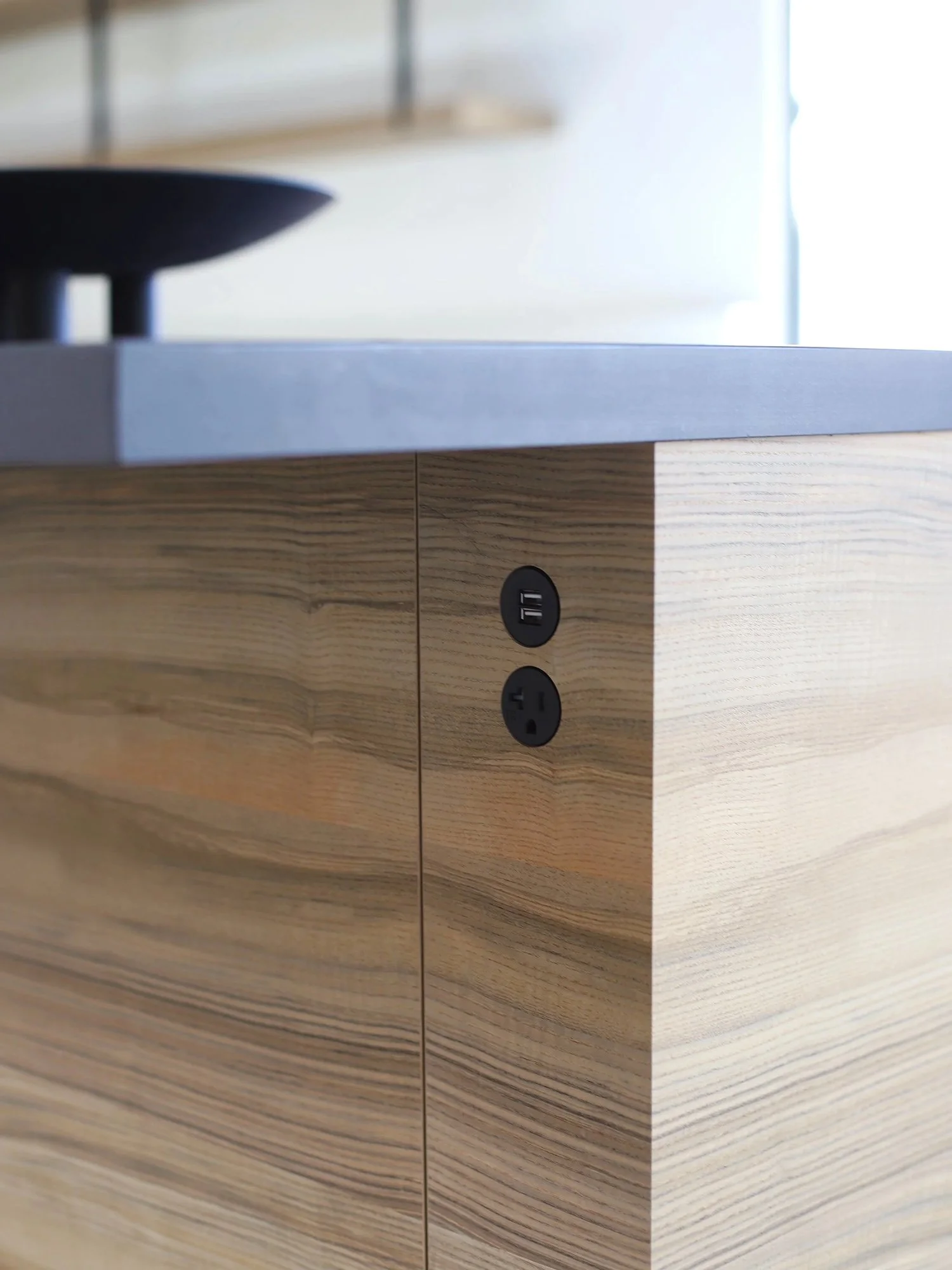 Lacuna kitchen island with 22 System flush mount patented outlets integrated into wood cabinetry