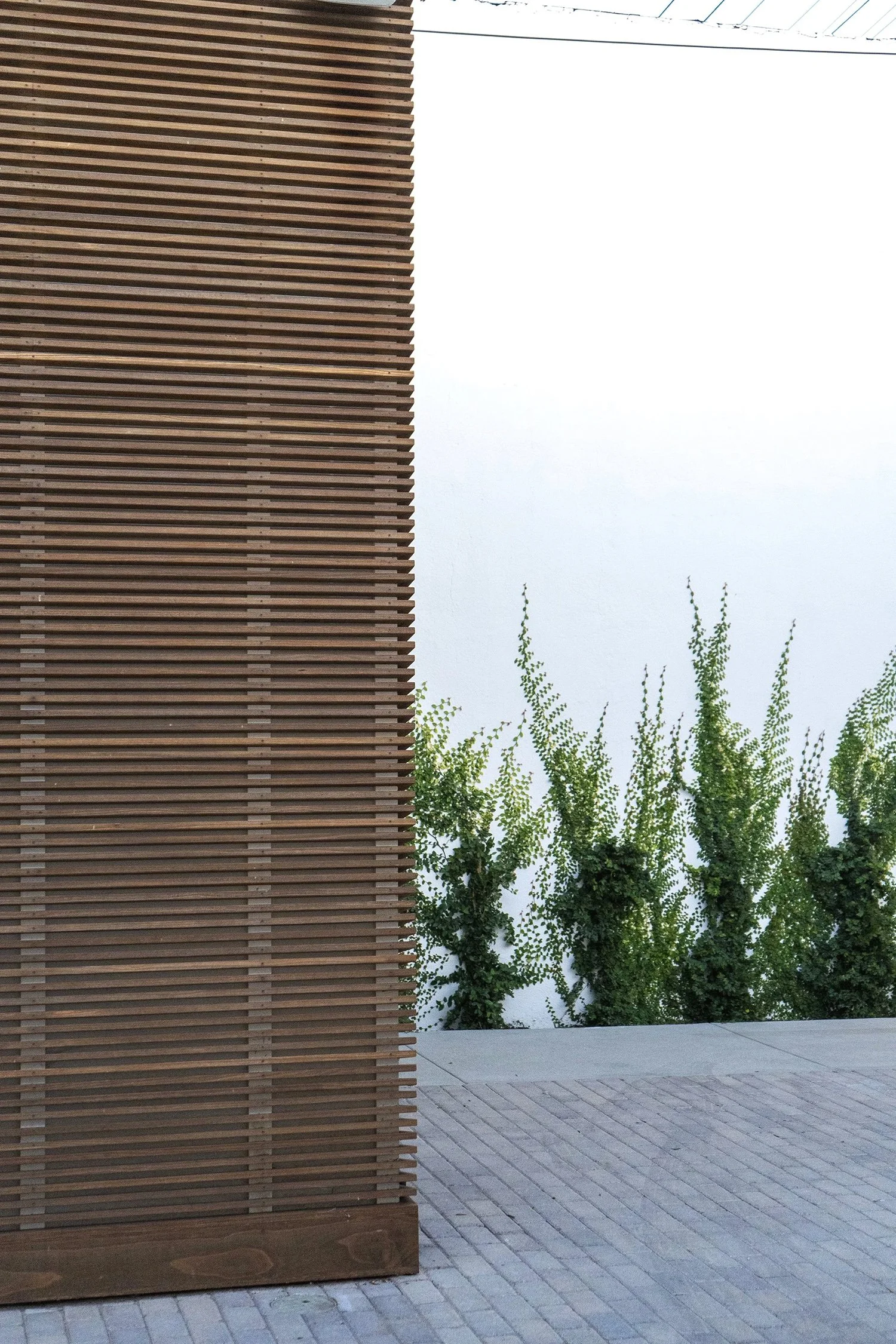 Lacuna exterior restroom building with Kebony sustainably modified wood horizontal slats West Adams Los Angeles