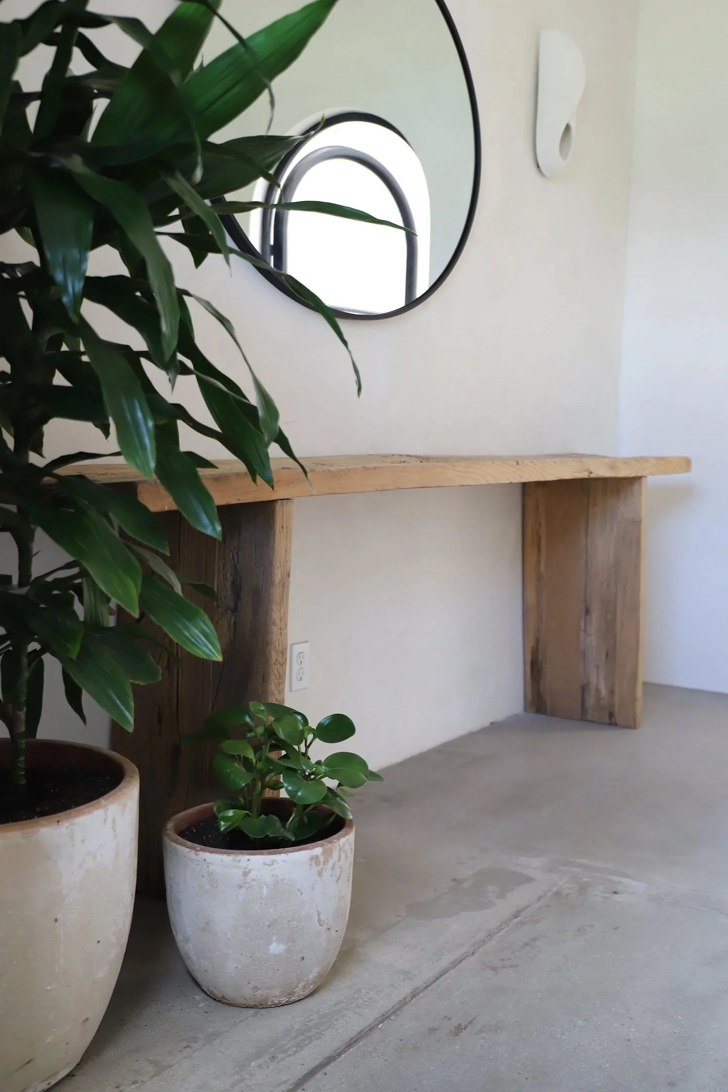 Lacuna entry with vintage rustic wood console table and terracotta planters by Berbere Imports Los Angeles