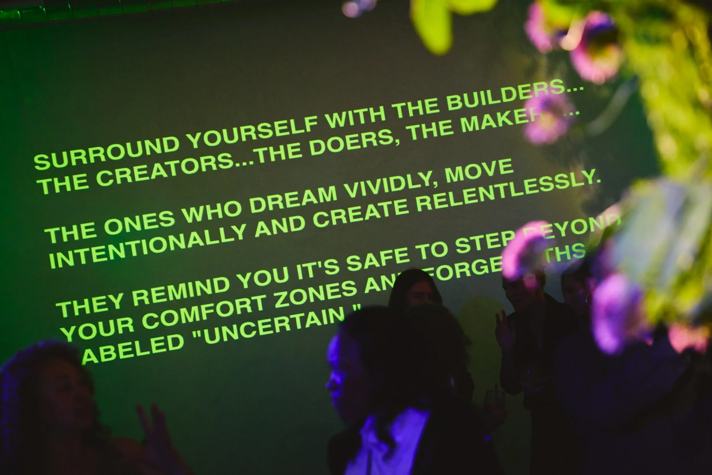Matt Gottesman quote projected on the wall at Lacunafest at Lacuna Space reading Surround Yourself With the Builders the Creators the Doers the Makers