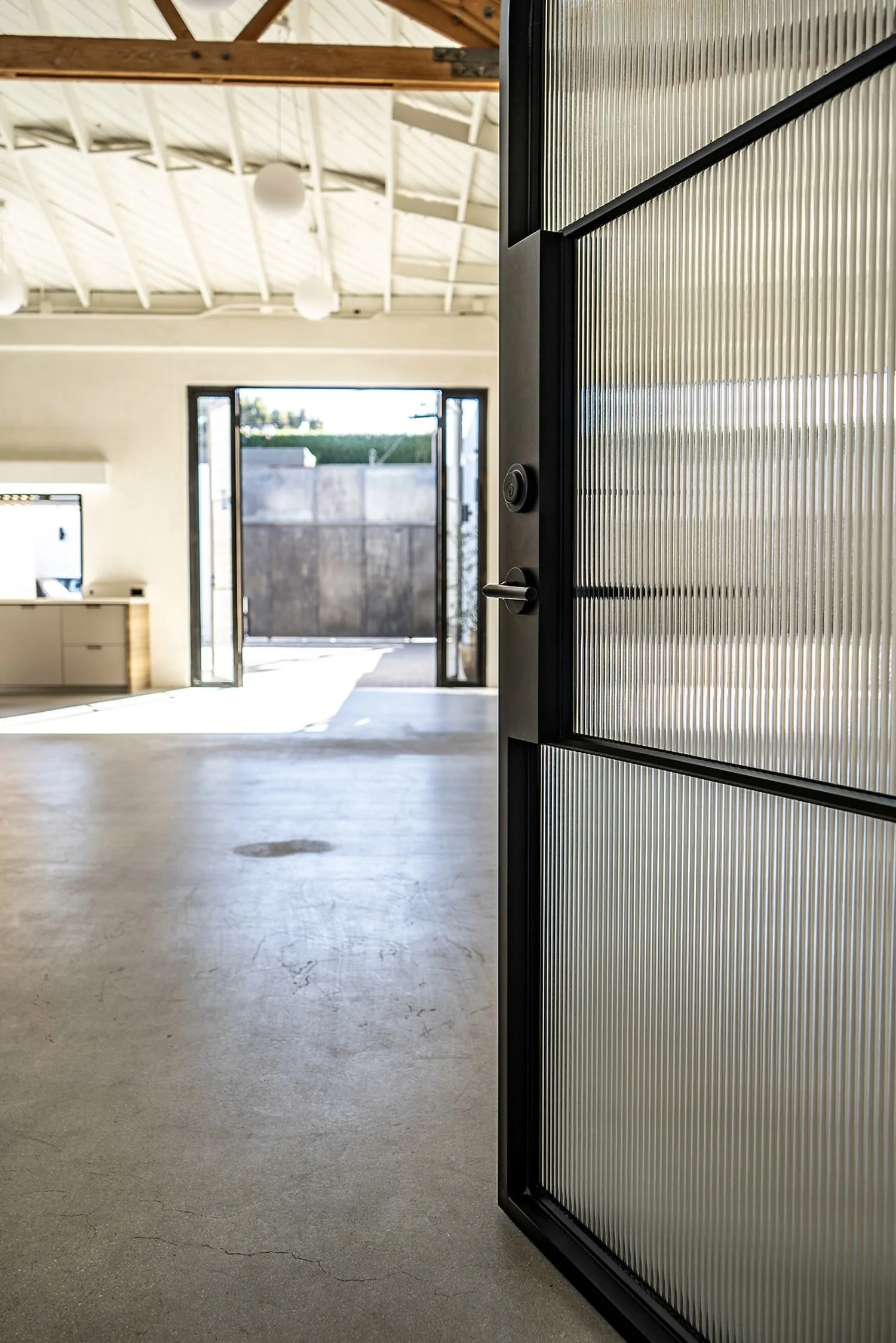 Lacuna glass door entry leading to outdoor courtyard West Adams