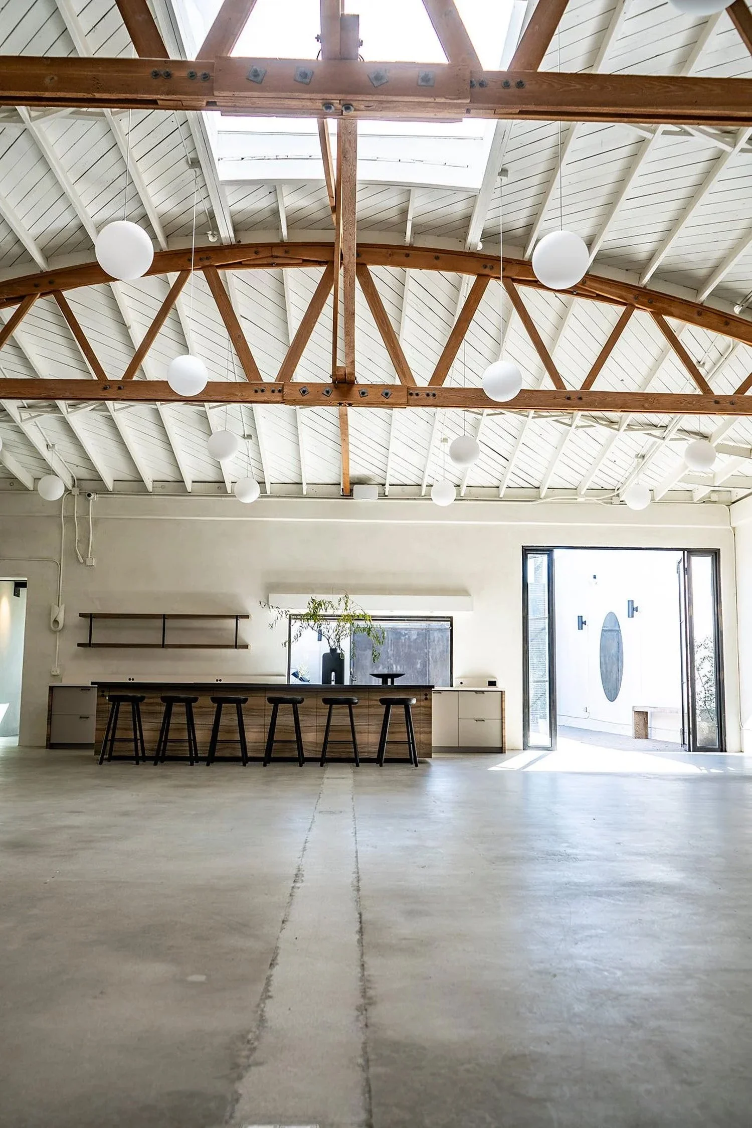 Lacuna event space kitchen island and bow truss ceiling West Adams Los Angeles