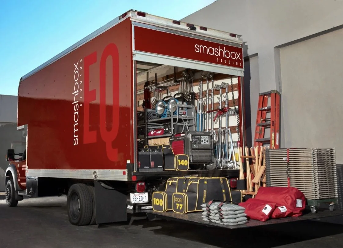 Smashbox Studios red equipment truck loaded with professional photo and video production gear including lighting and grip equipment