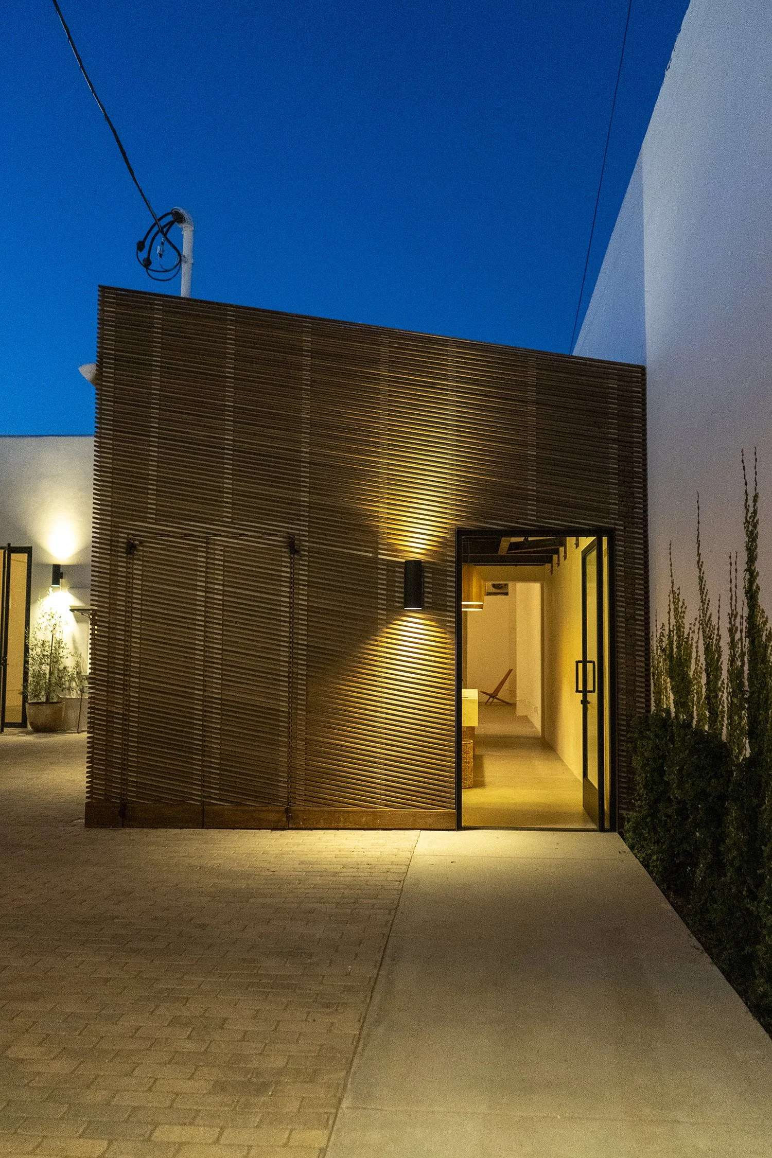 Lacuna Kebony wood exterior building at night West Adams Los Angeles