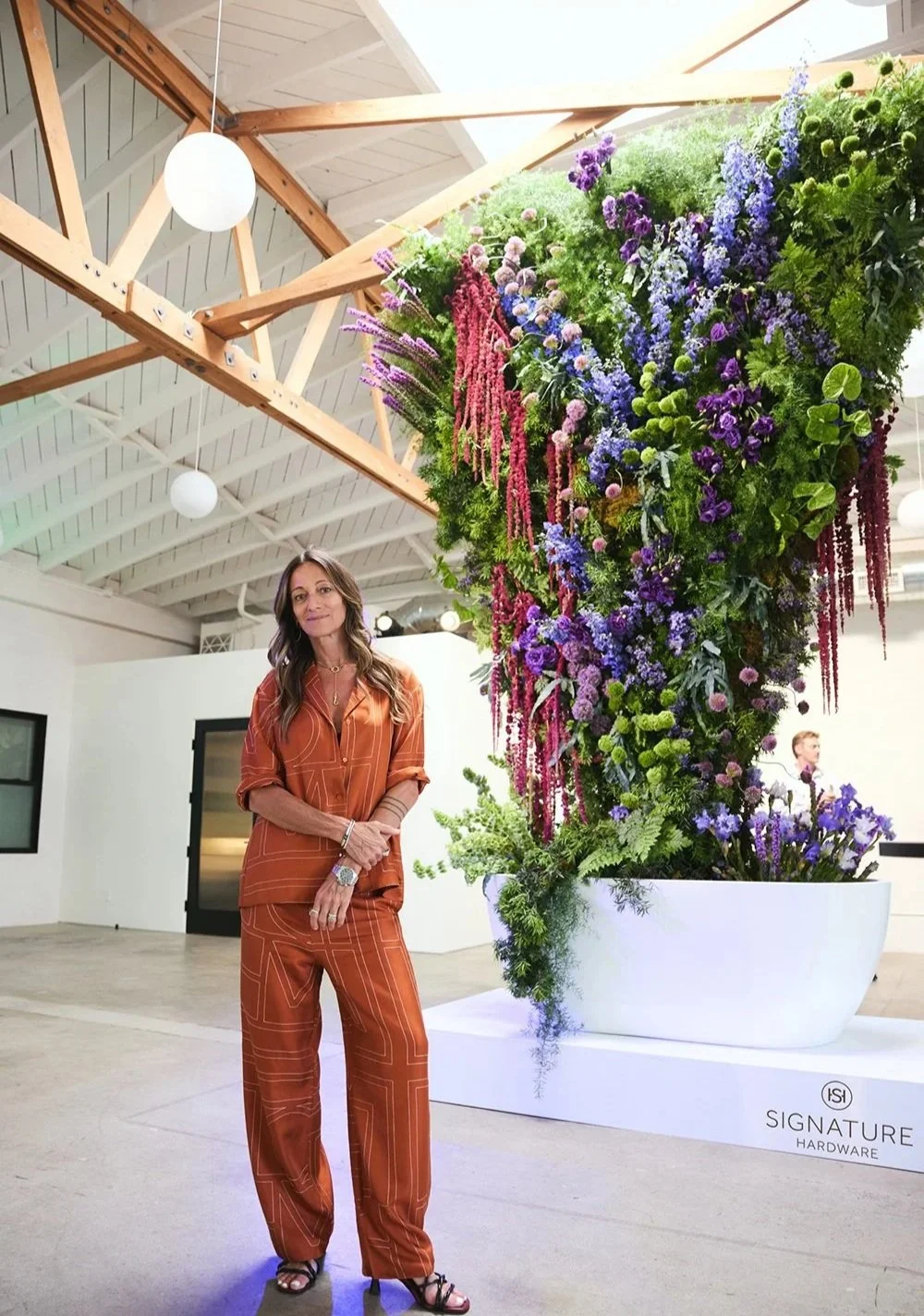 Dre Shapiro and floral sculpture by Rogue and Fox