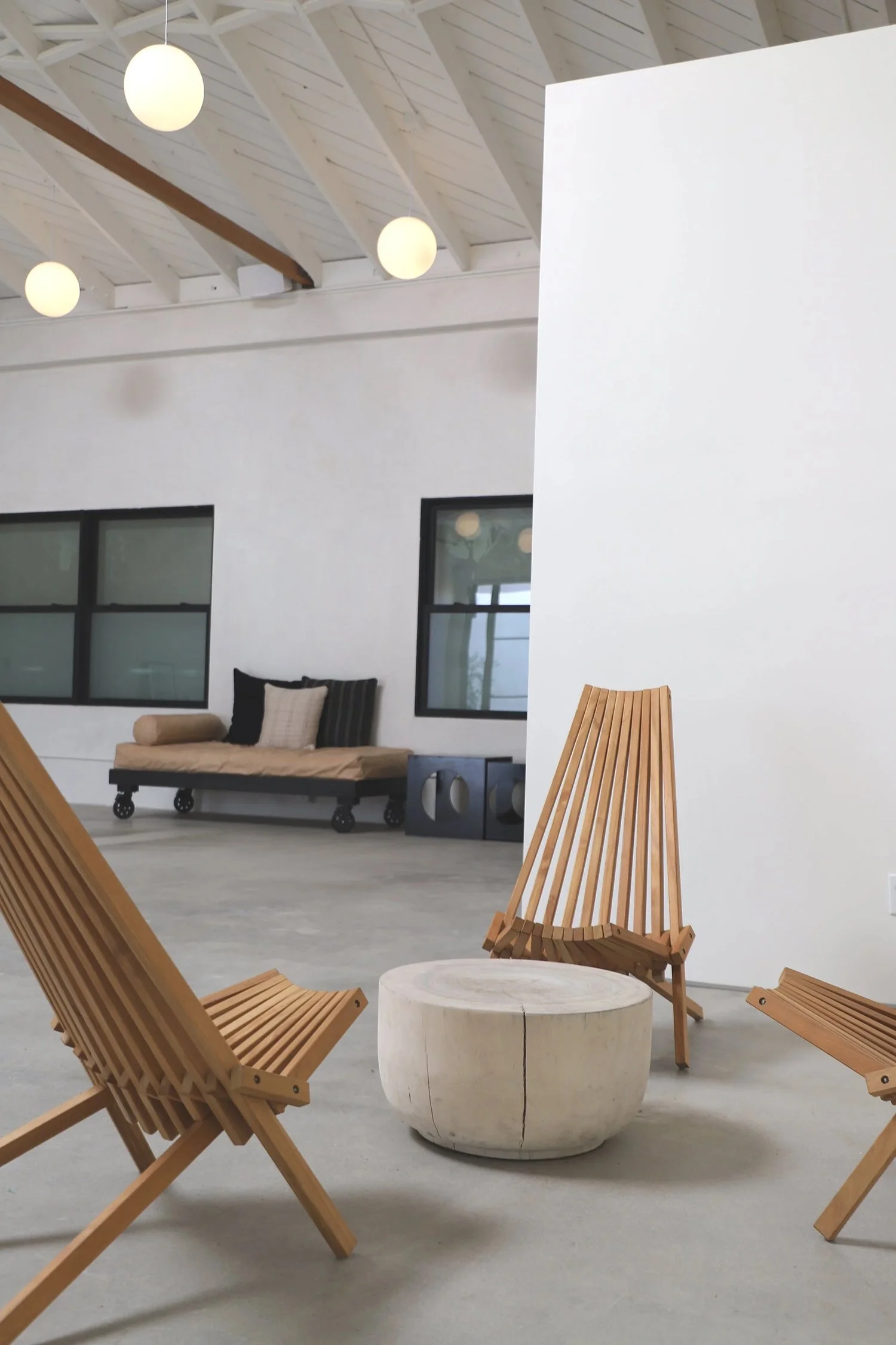 Lacuna interior with Panamericana Teak folding chairs by Industry of All Nations and leather daybed