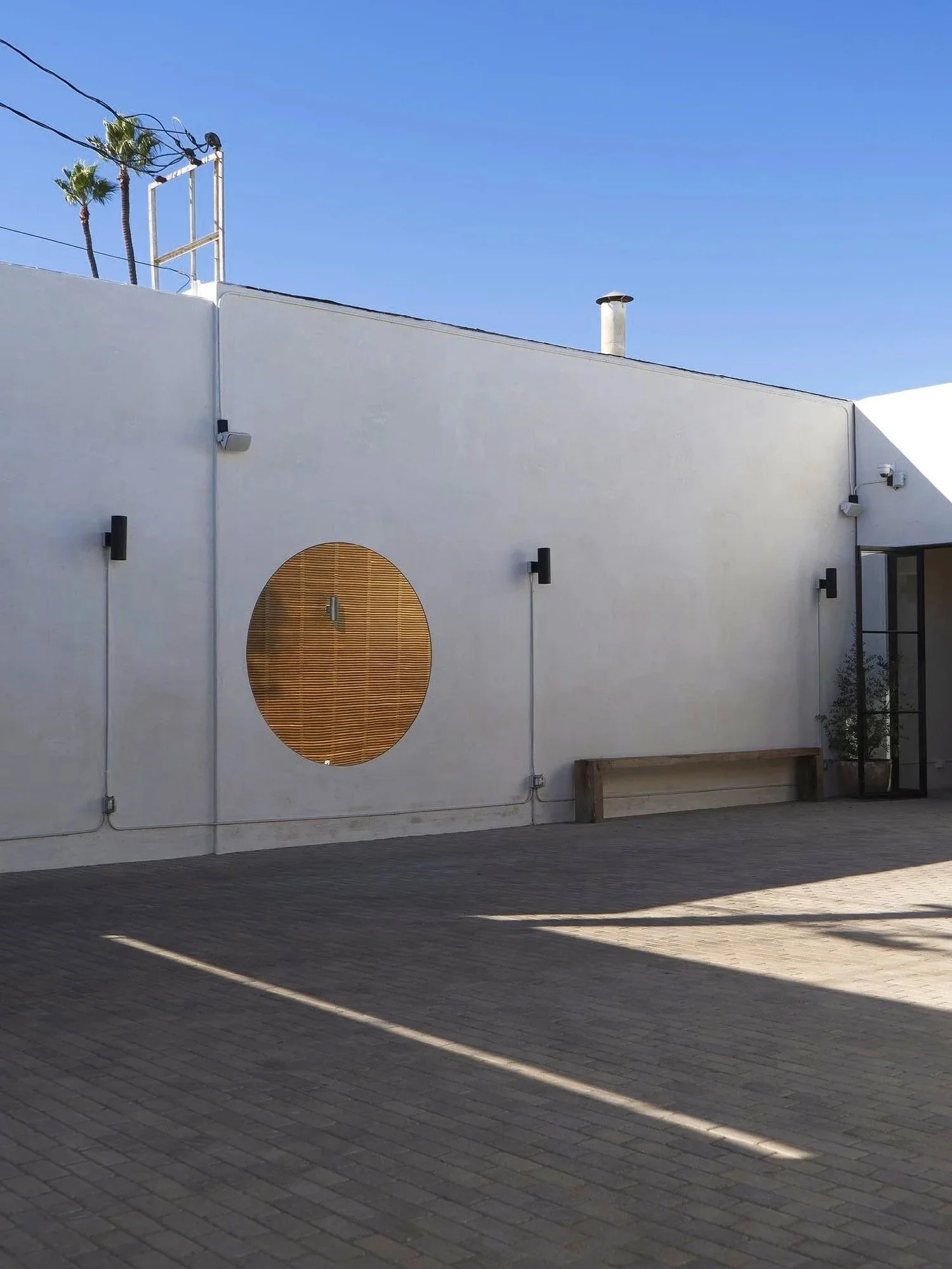 Lacuna exterior restroom building at night with Kebony wood and HEDsouth lighting West Adams Los Angeles