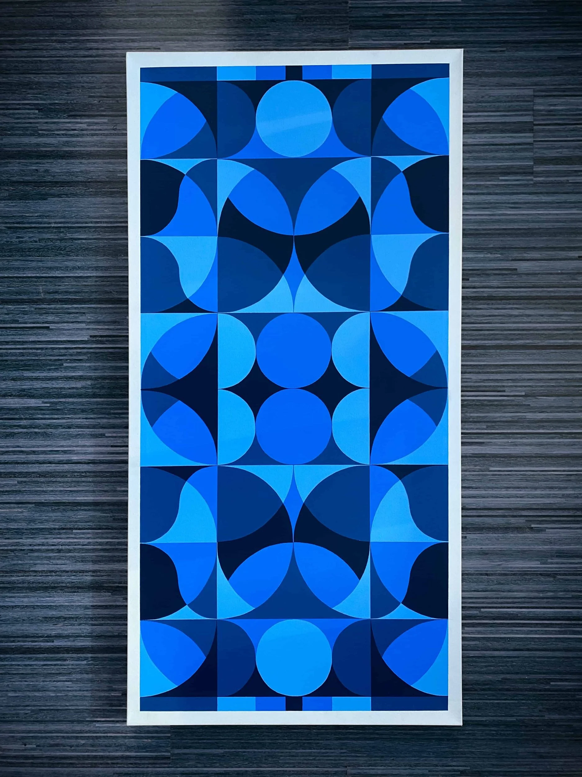  Blue geometric acrylic painting featuring repeating circular patterns, modern color blocking, and balanced minimalist abstract design 