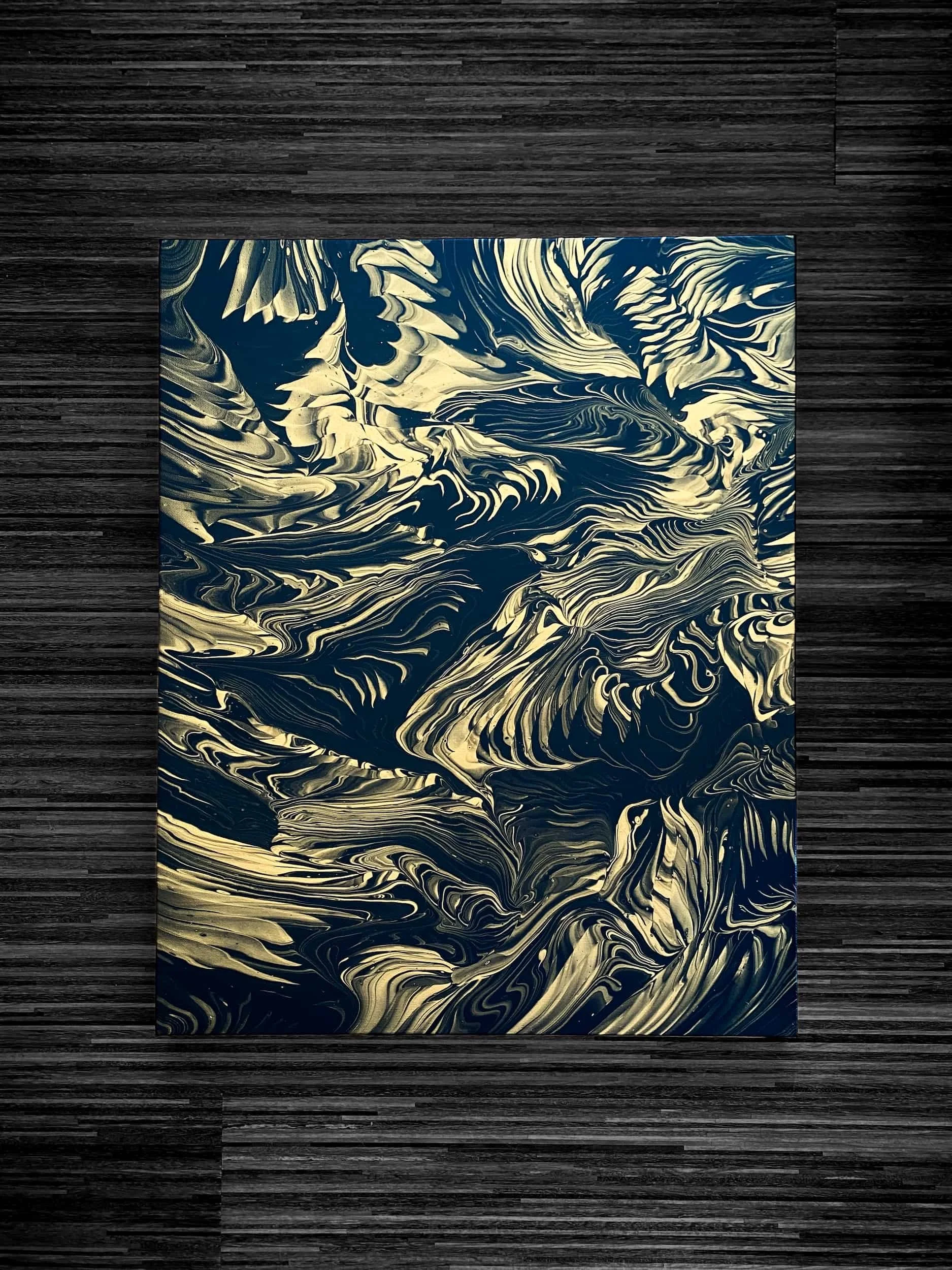  Dark fluid acrylic painting with dramatic black-and-gold marbled textures, swirling organic movement, and moody abstract energy 