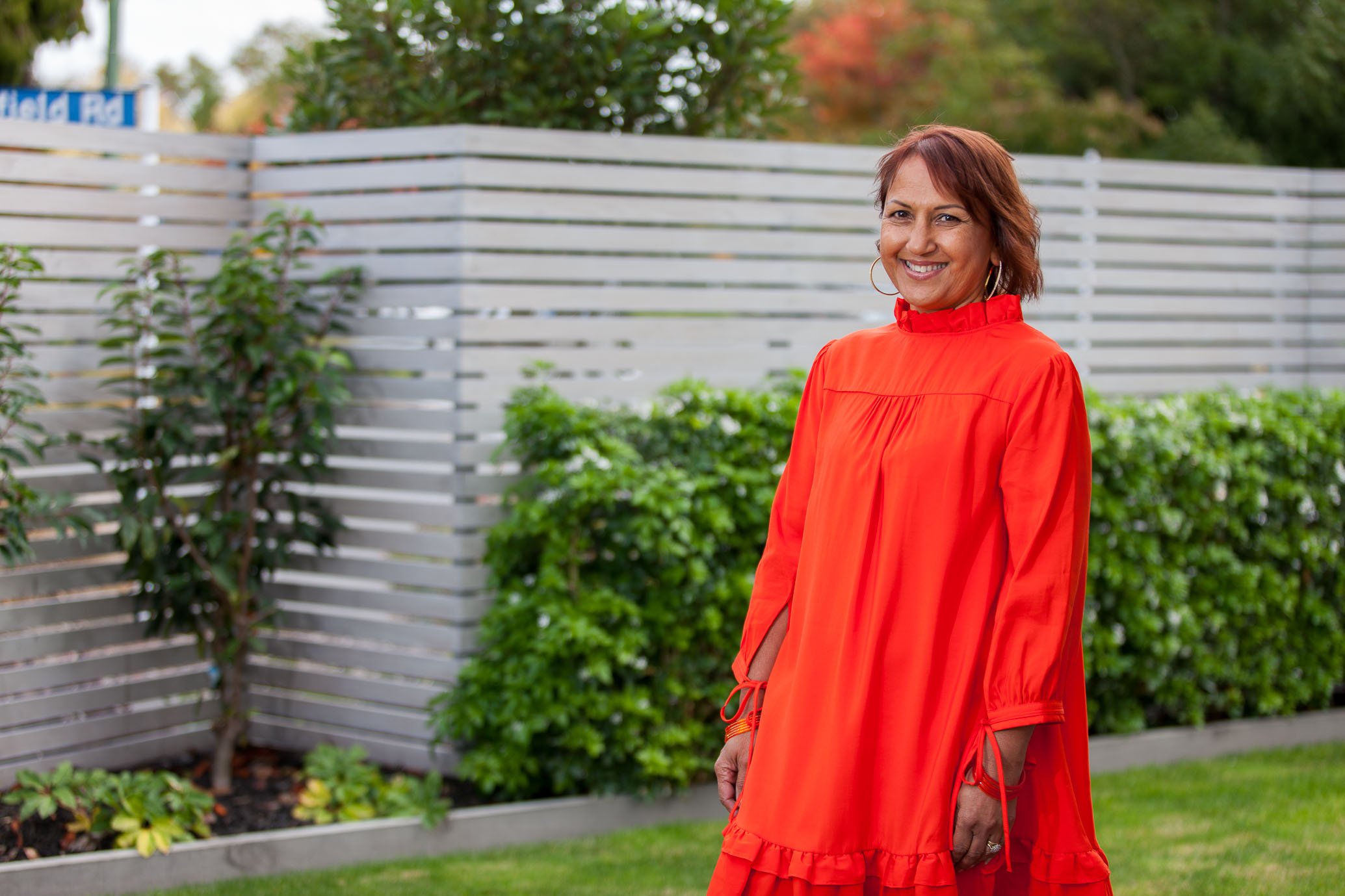 Usha in a red dress outside.jpg