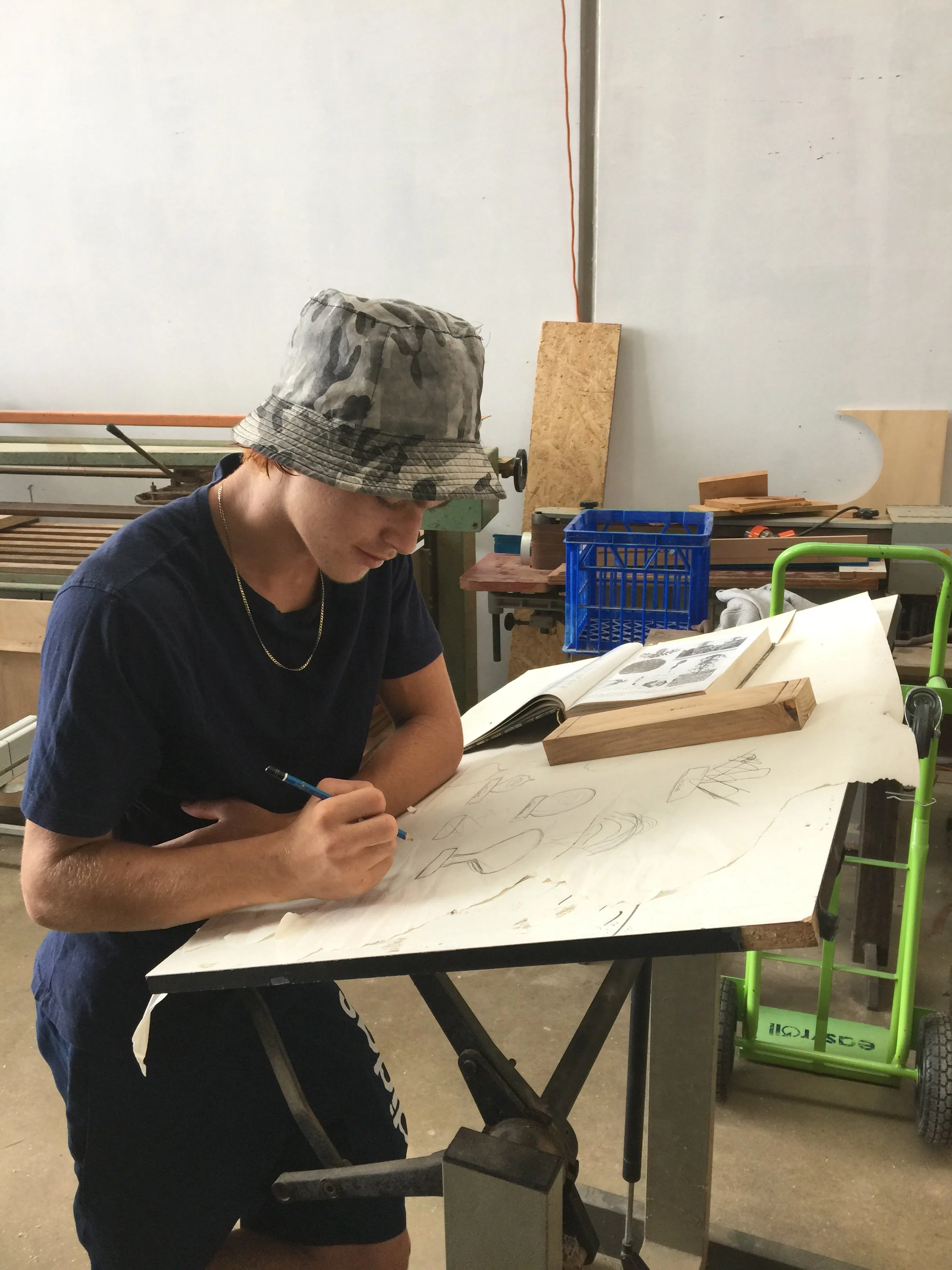 studentwithdesigndrawings.jpg