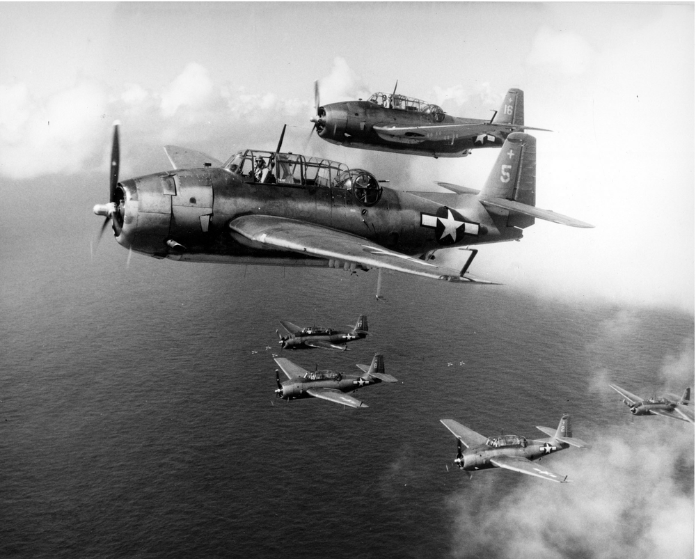 TBM-1C+Avenger+aircraft+flying+from+the+USS+Intrepid,+1944;+note+five+low+flying+aircraft+below+lower+element+copy.png