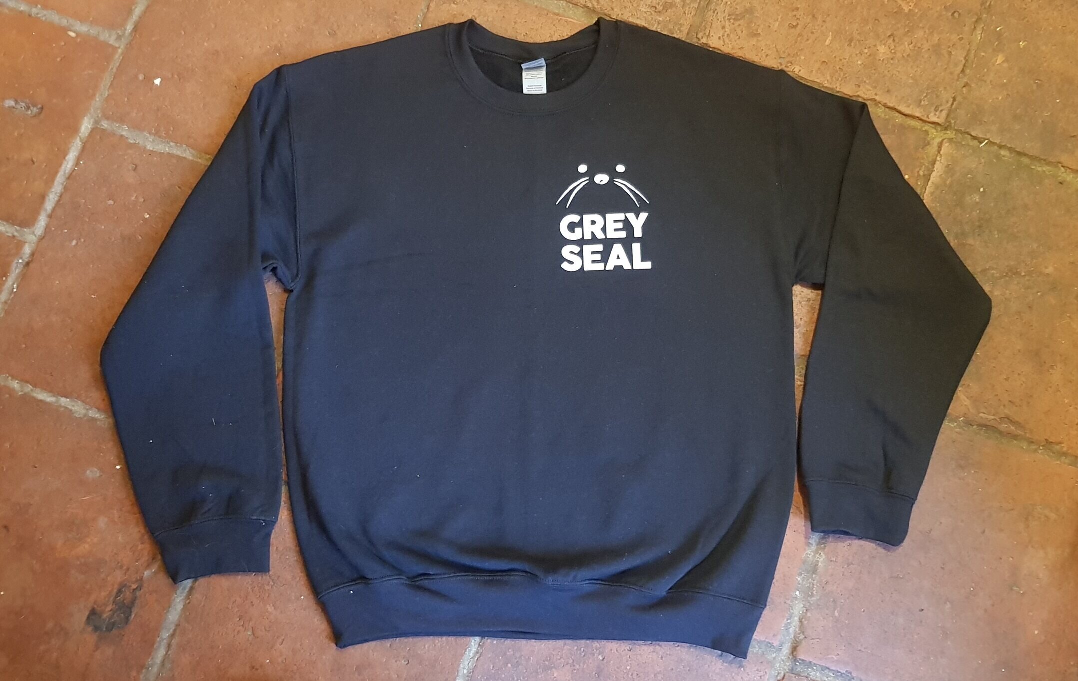 Grey Seal Roasters Sweatshirt in Black with white seal face logo and text