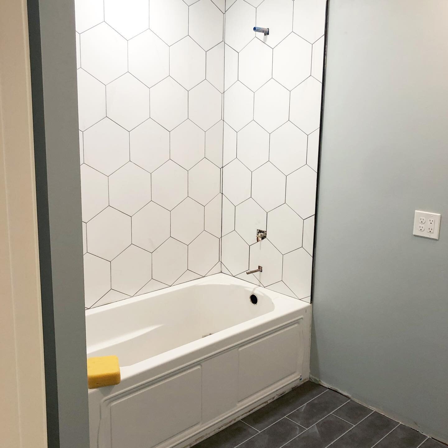 White hex, black trim, black floor... we&rsquo;re liking the way this bathroom is coming together!