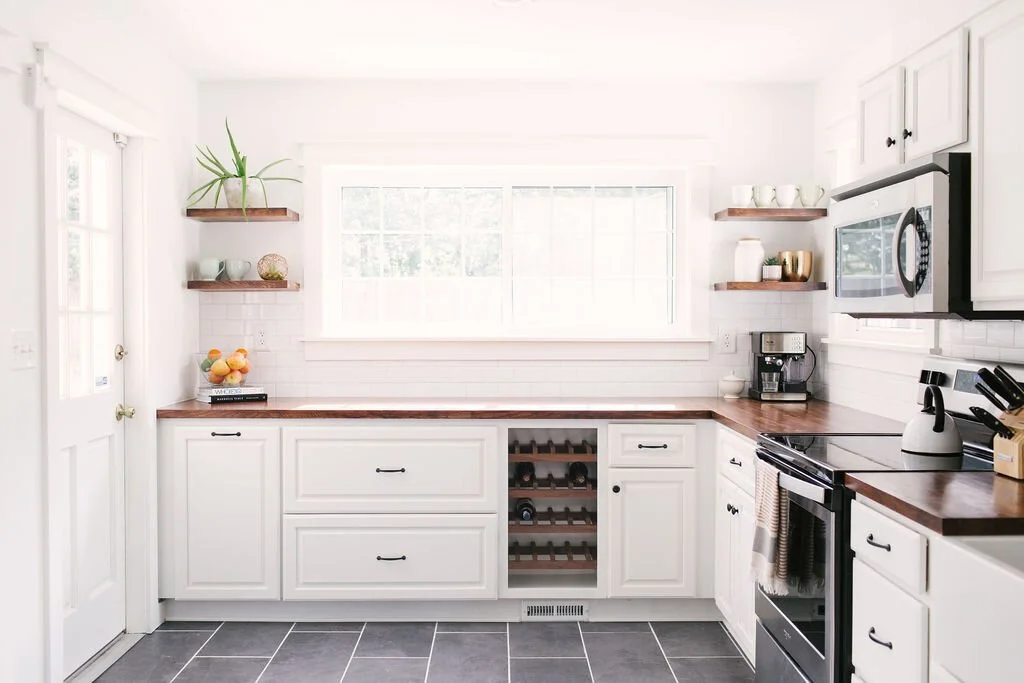 Kitchen makeover Birmingham AL — new cabinet doors, countertops, backsplash, and lighting refresh by Canebrake Construction