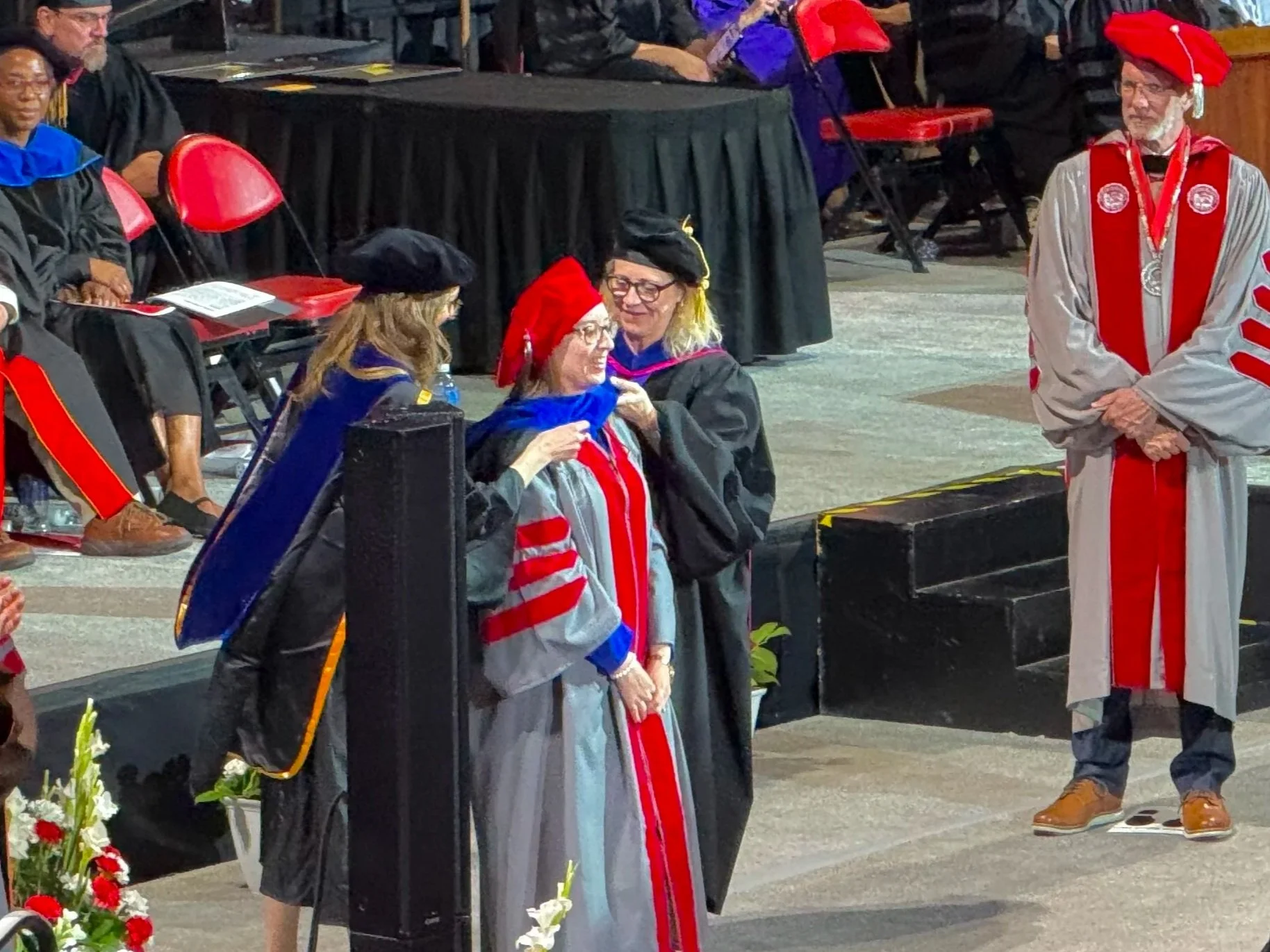 Stacey being hooded at graduation