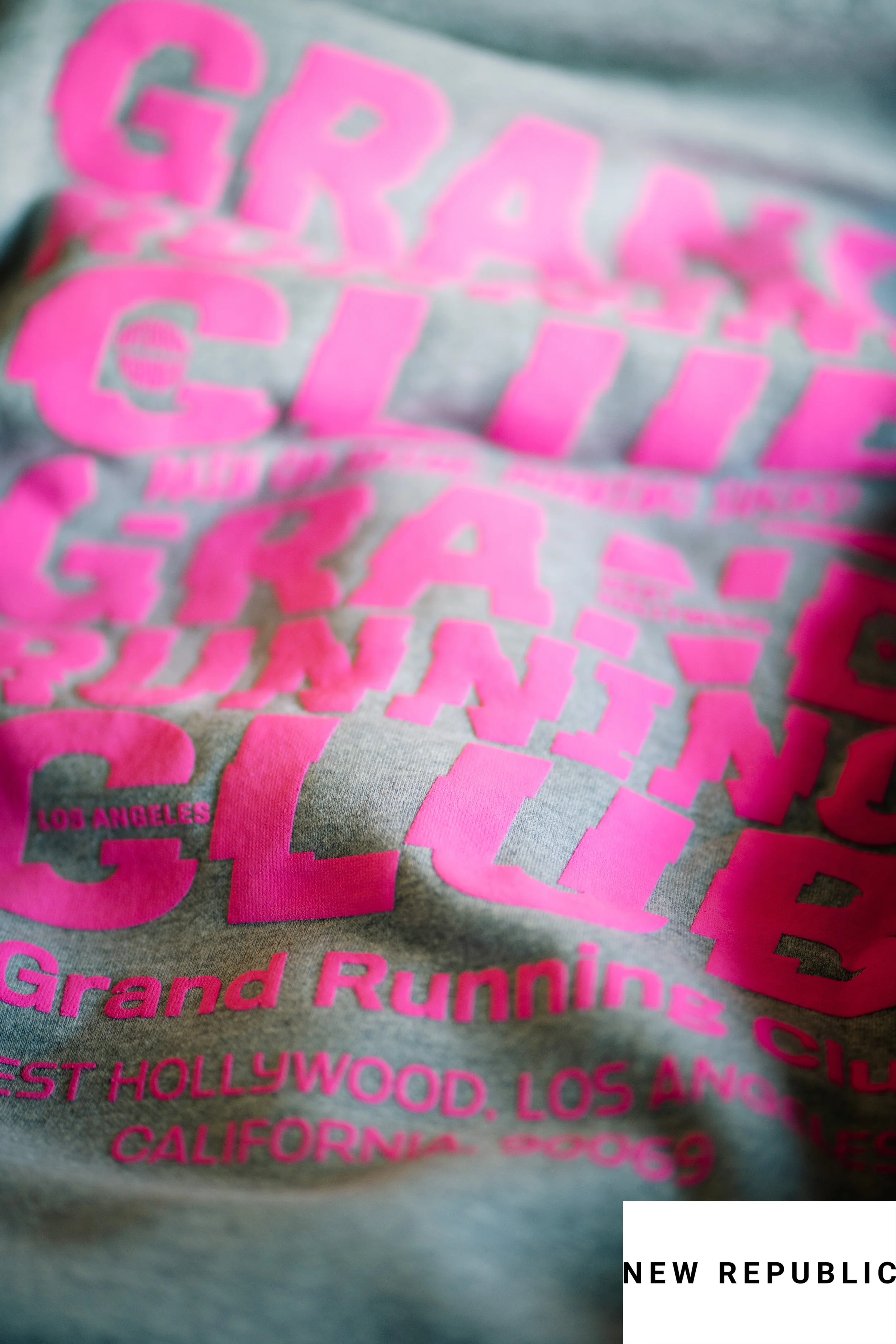 Close-up of gray hoodie with pink text promoting Grand Rumble marathon in Los Angeles and Hollywood.
