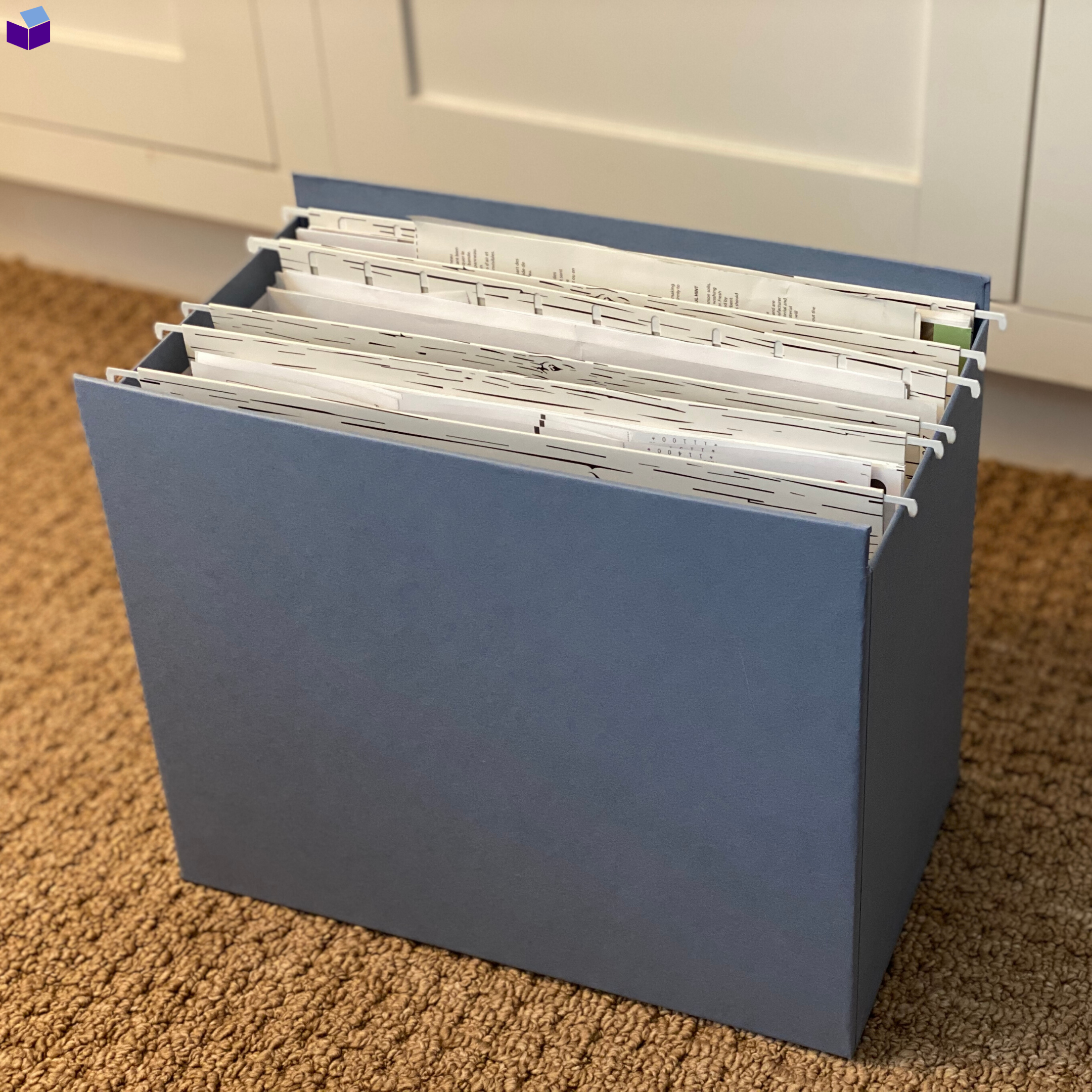 Blue grey filing box with file folders.