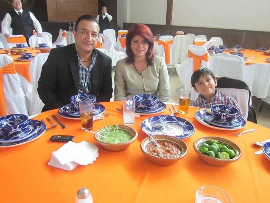  Santiago having a meal with his parents, Mexico, 2015 