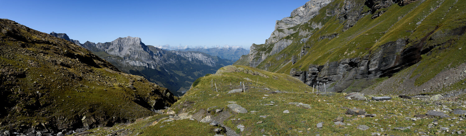 Steep steps on mountain path to the green alpine valley