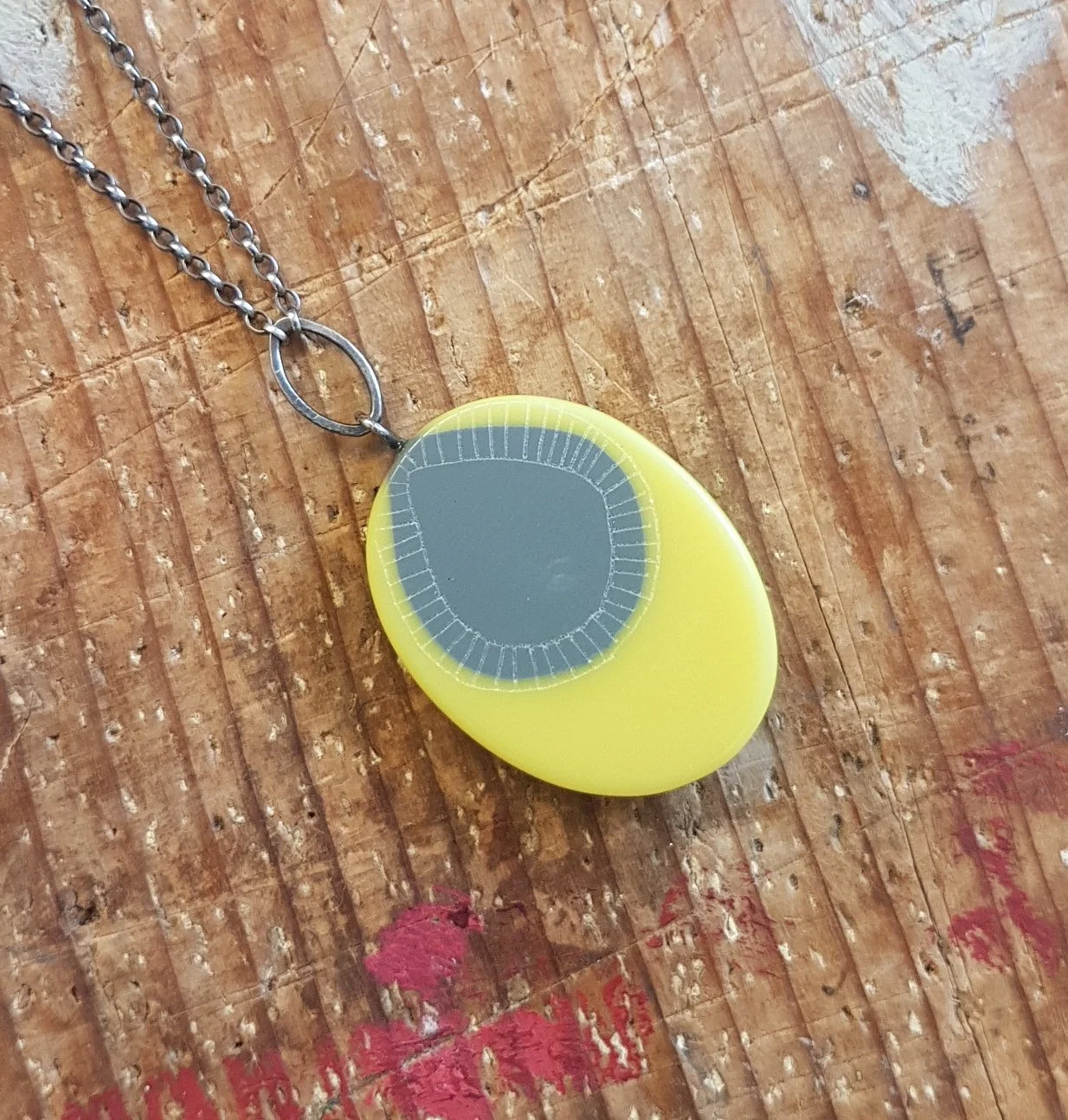 yellow and grey oval pendant with link