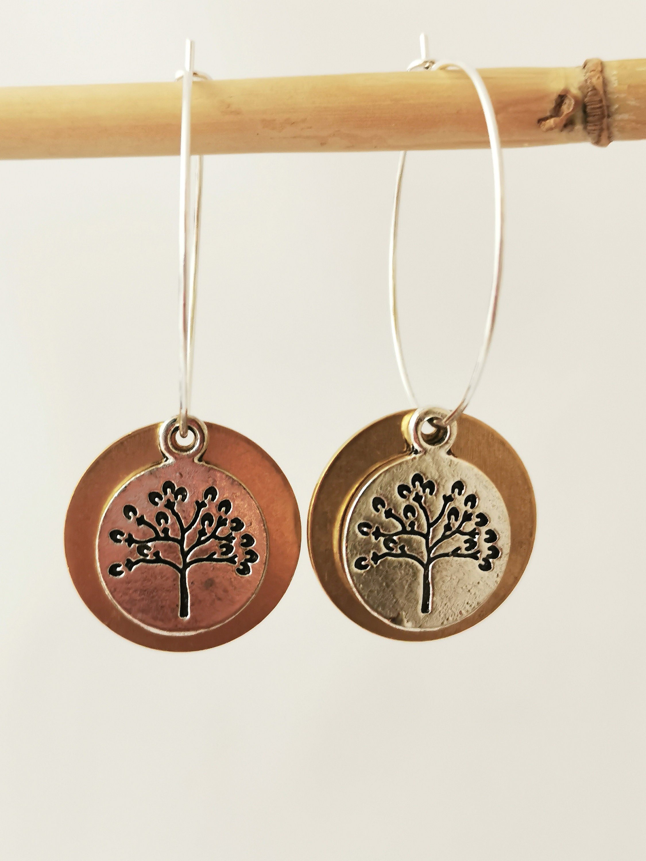 Tree of life hoop earrings, silver and bronze coloured discs with tree of life.