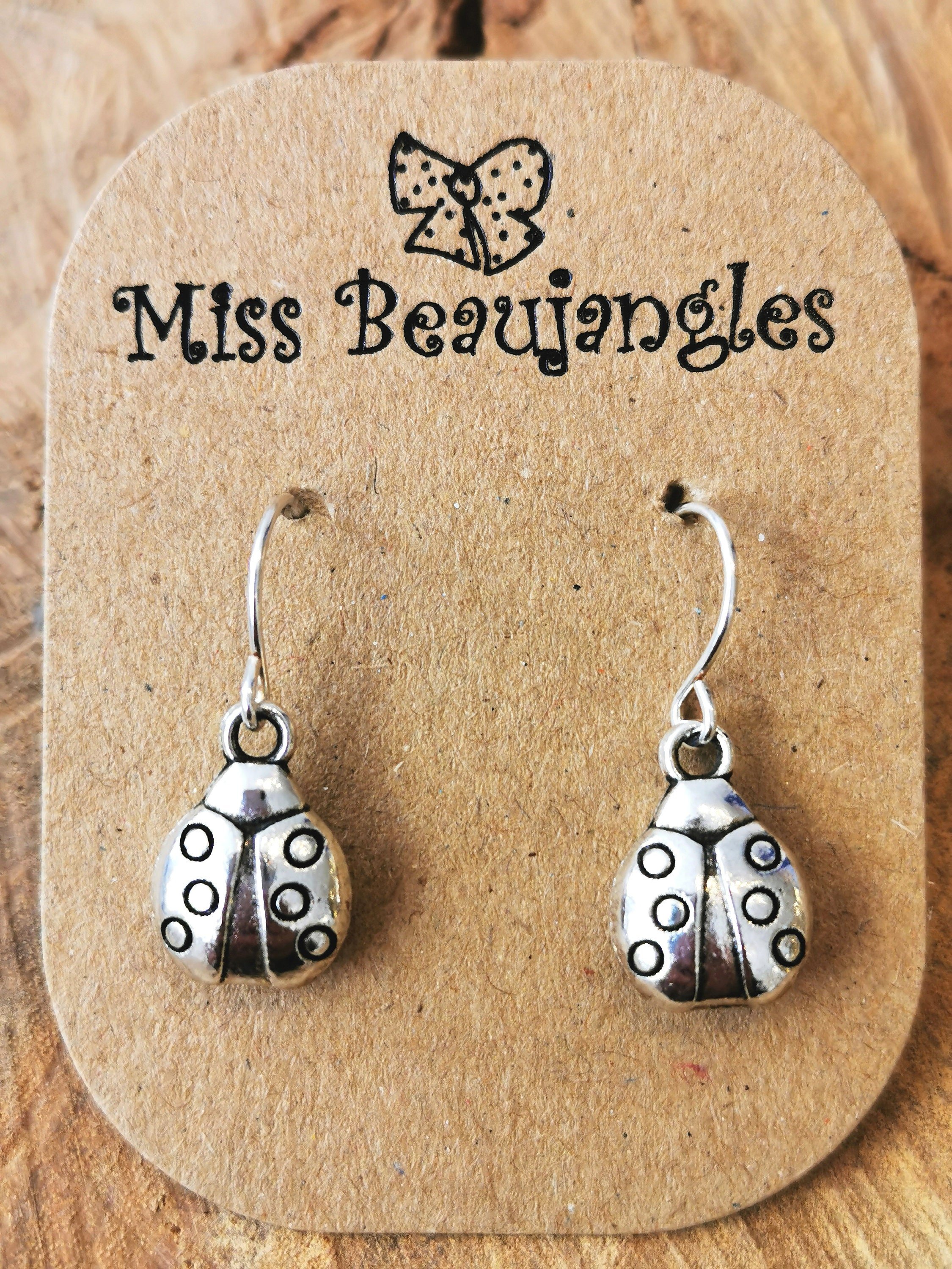 Dangly silver sausage dog earrings Silver plated hypoallergenic nickel  free  Miss Beaujangles