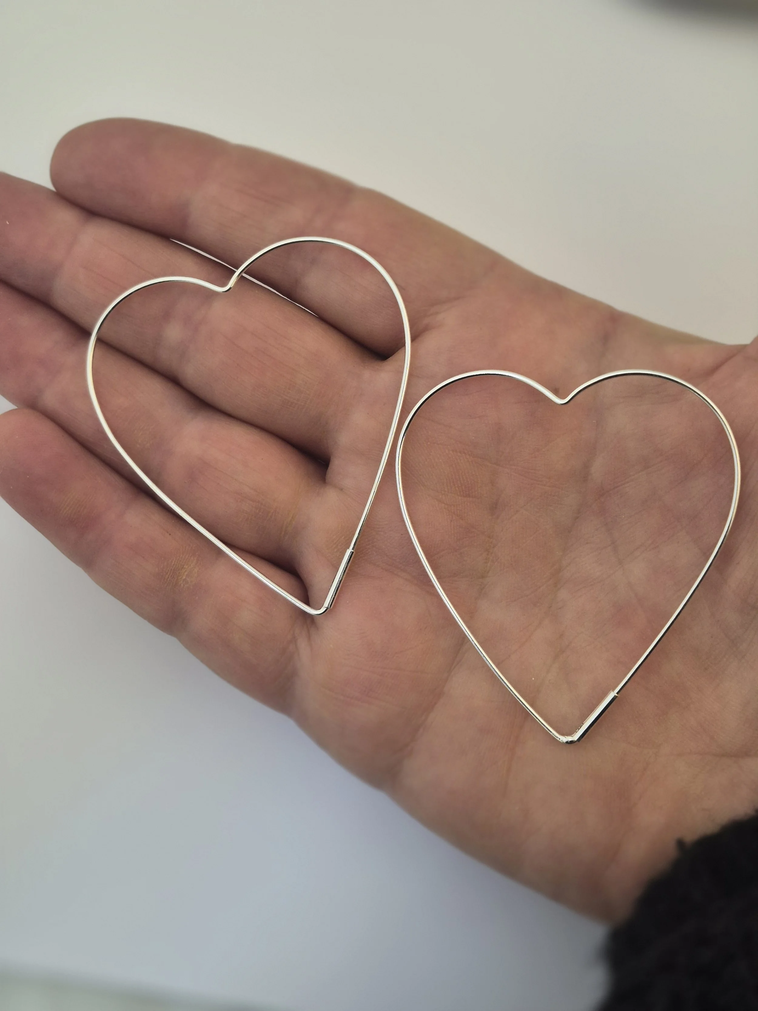 Large sterling silver heart shaped hoop earrings