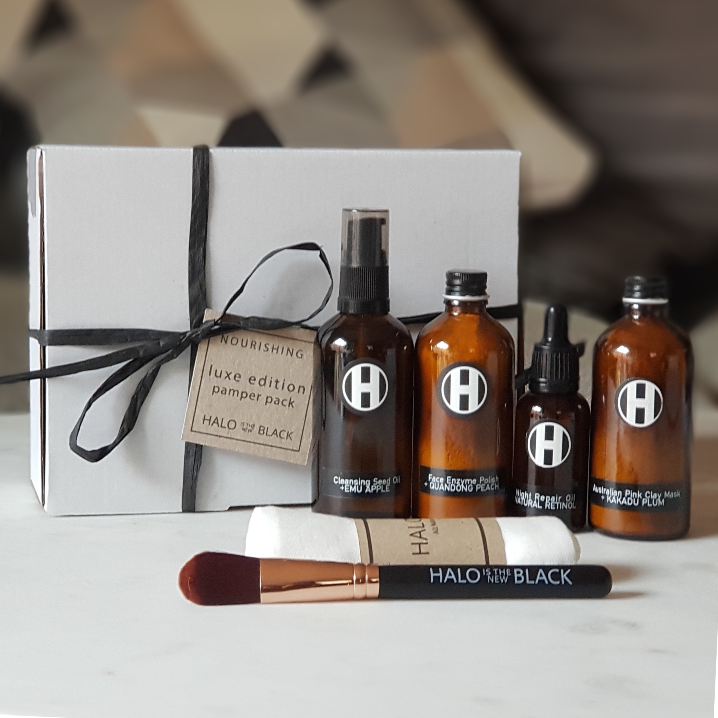The Nourishing Deluxe Pamper Pack by Halo is the New Black Skincare   Nourishing Deluxe Pamper Pack includes Emu Apple Cleansing oil, Quondong Peach Face Enzyme Polish,  Natural Retinol Face oil serum  and a Kakadu Plum Australian Pink Clay Mask.