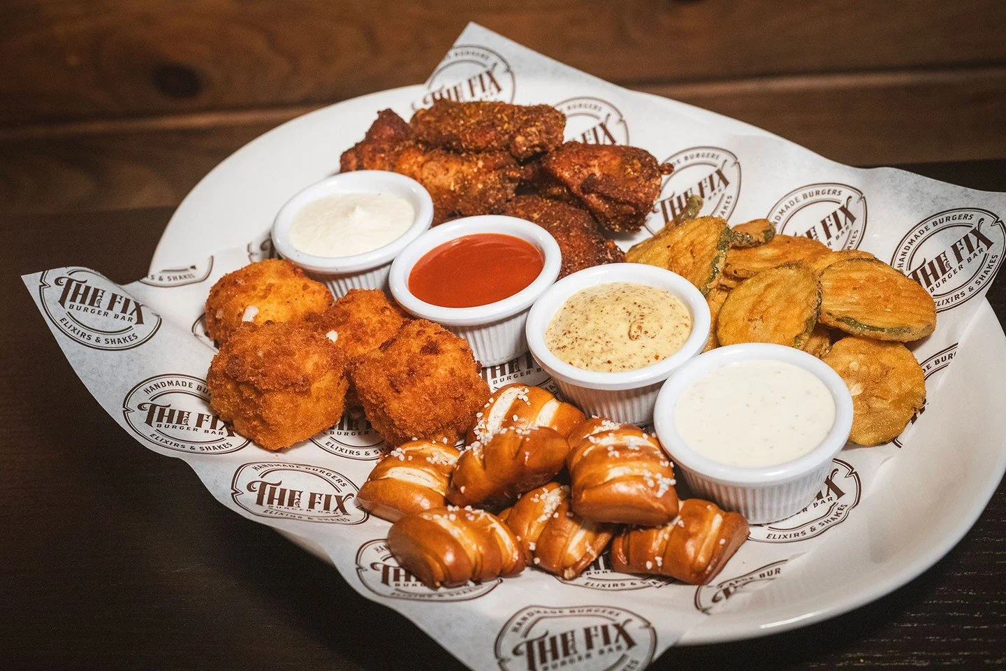 The Fix Sampler is back and better than ever. Now with chicken wings (choice of flavor), fried pickles, pretzel bites, and our NEW mac &amp; cheese bites! The perfect start to every visit. Available in Worcester and Marlborough.