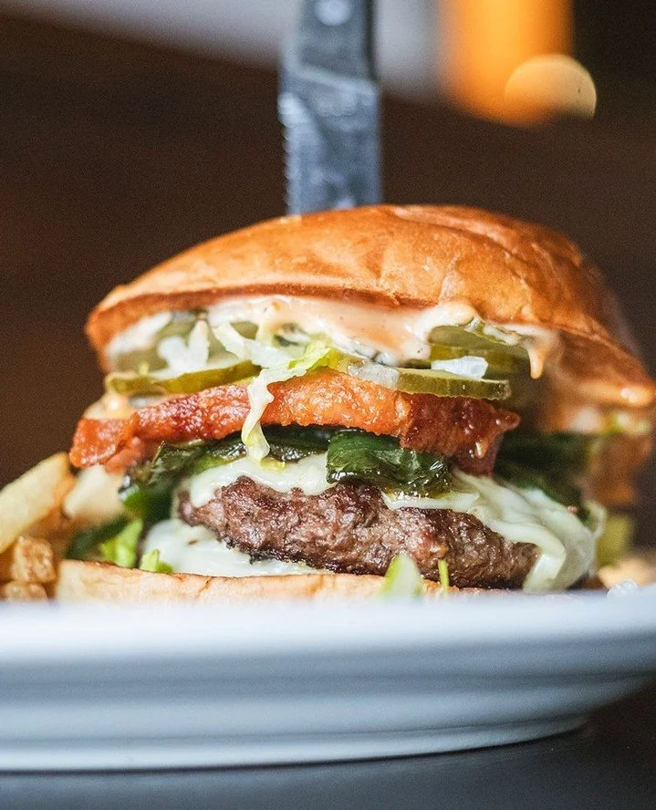 Th-th-th-that's all, folks! ⁠
⁠
"Porky&rsquo;s Revenge⁠" will have you squealing with joy after biting into two 4oz. house patties, pork belly, bacon, roasted poblano, pickles, American cheese, spicy BBQ aioli, and lettuce on a brioche bun.