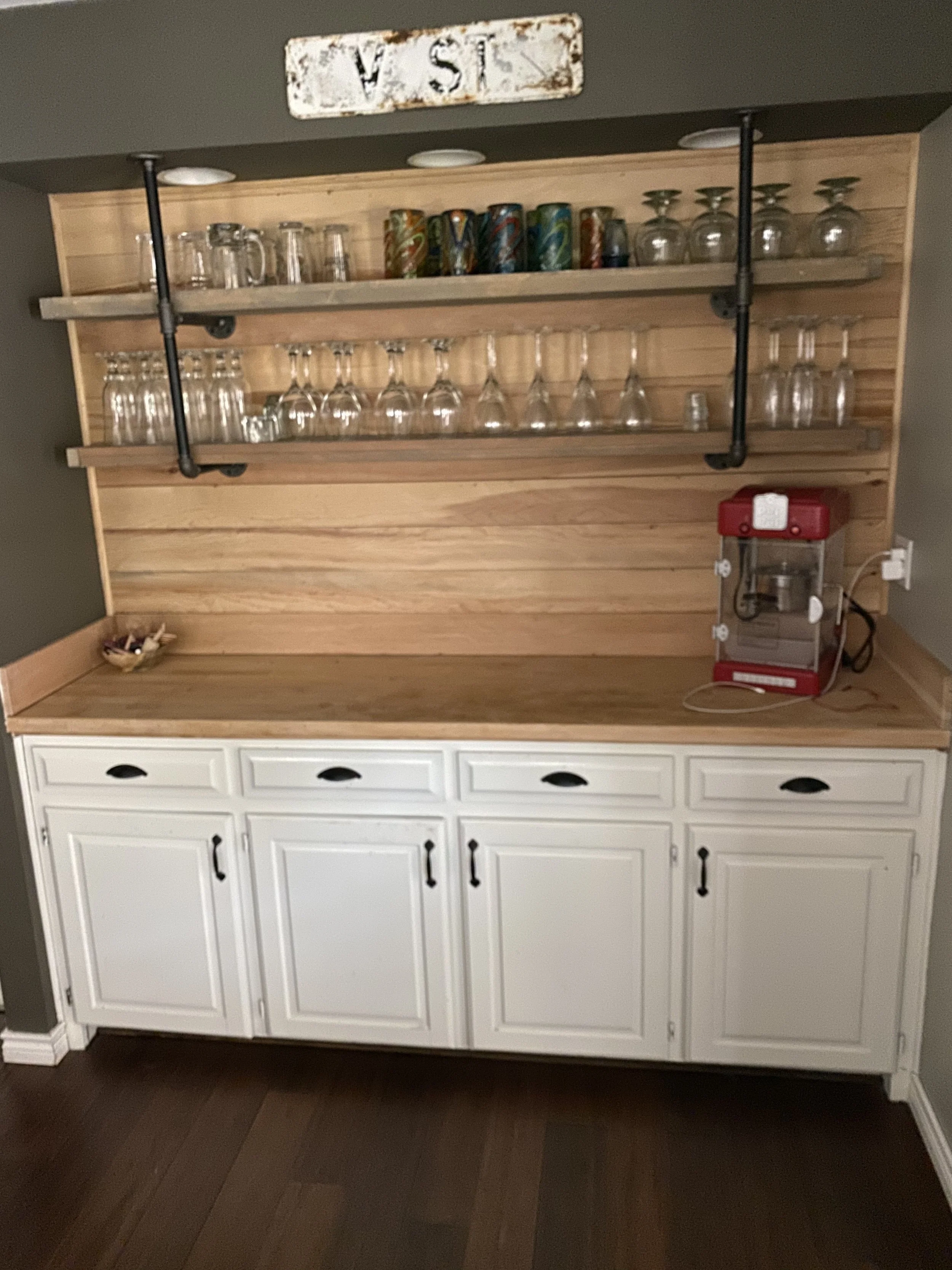  Demo old countertop and sink, added new countertop and custom shelving. 