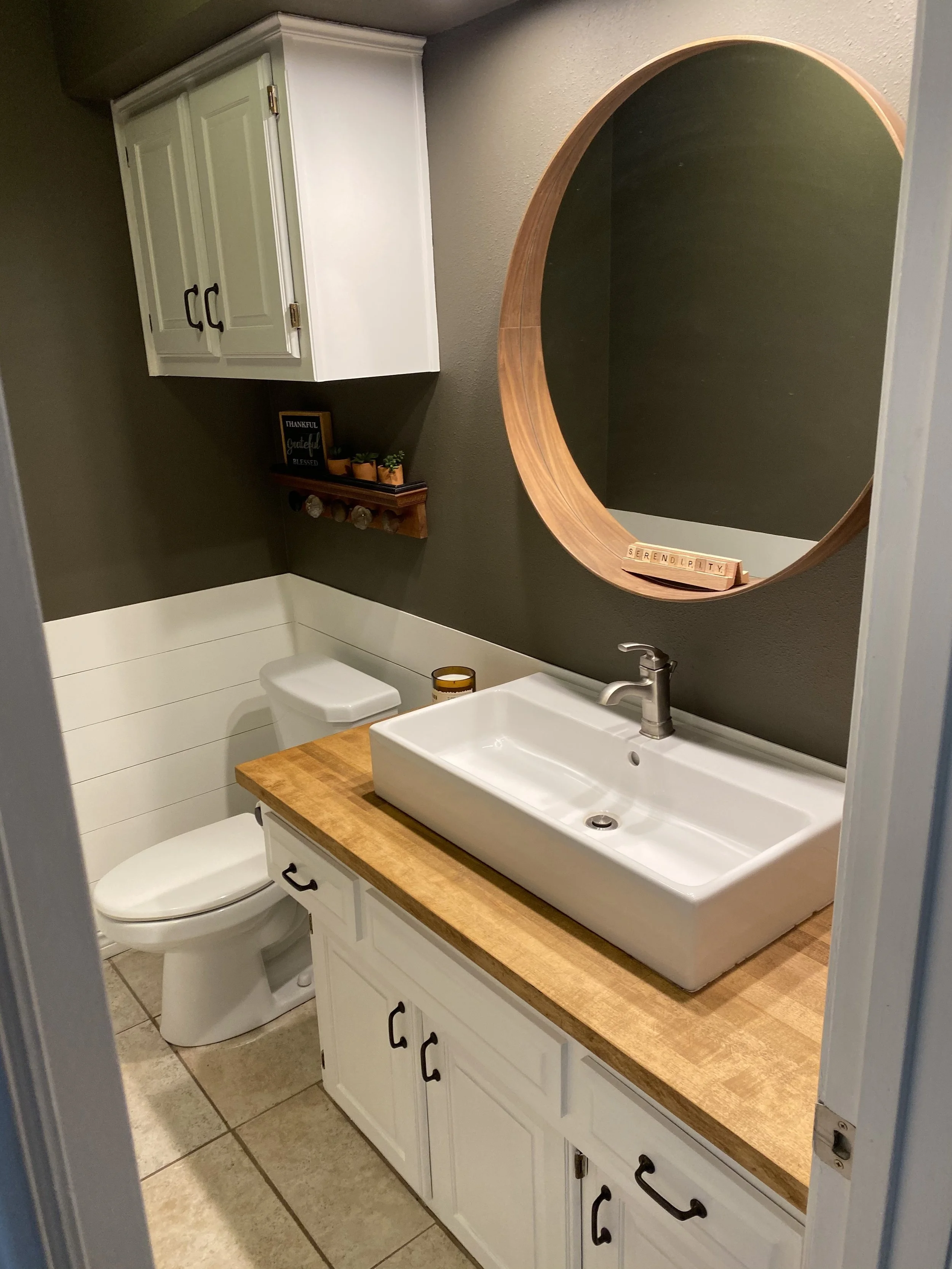  Removed old countertop, sink, mirror, light. Added new countertop, sink, paint. 