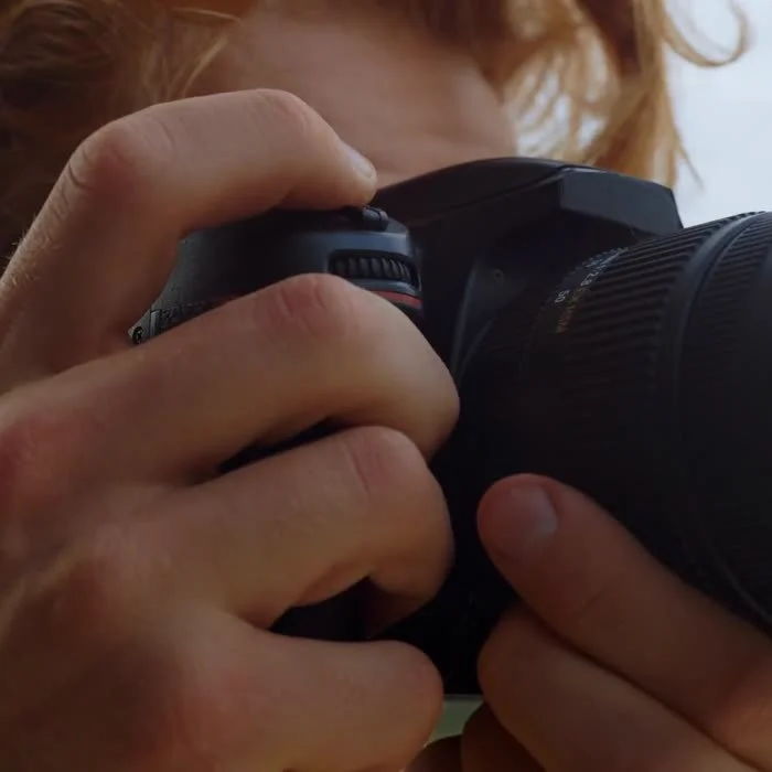 Close-up of a camera operator framing a shot