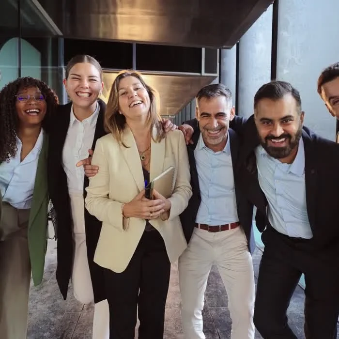 A diverse team of creative partners laughing together