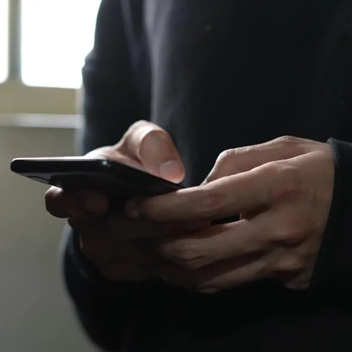 Hands scrolling content on a phone
