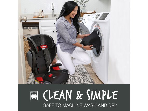 Woman placing car seat cover into her washing machine (Copy)